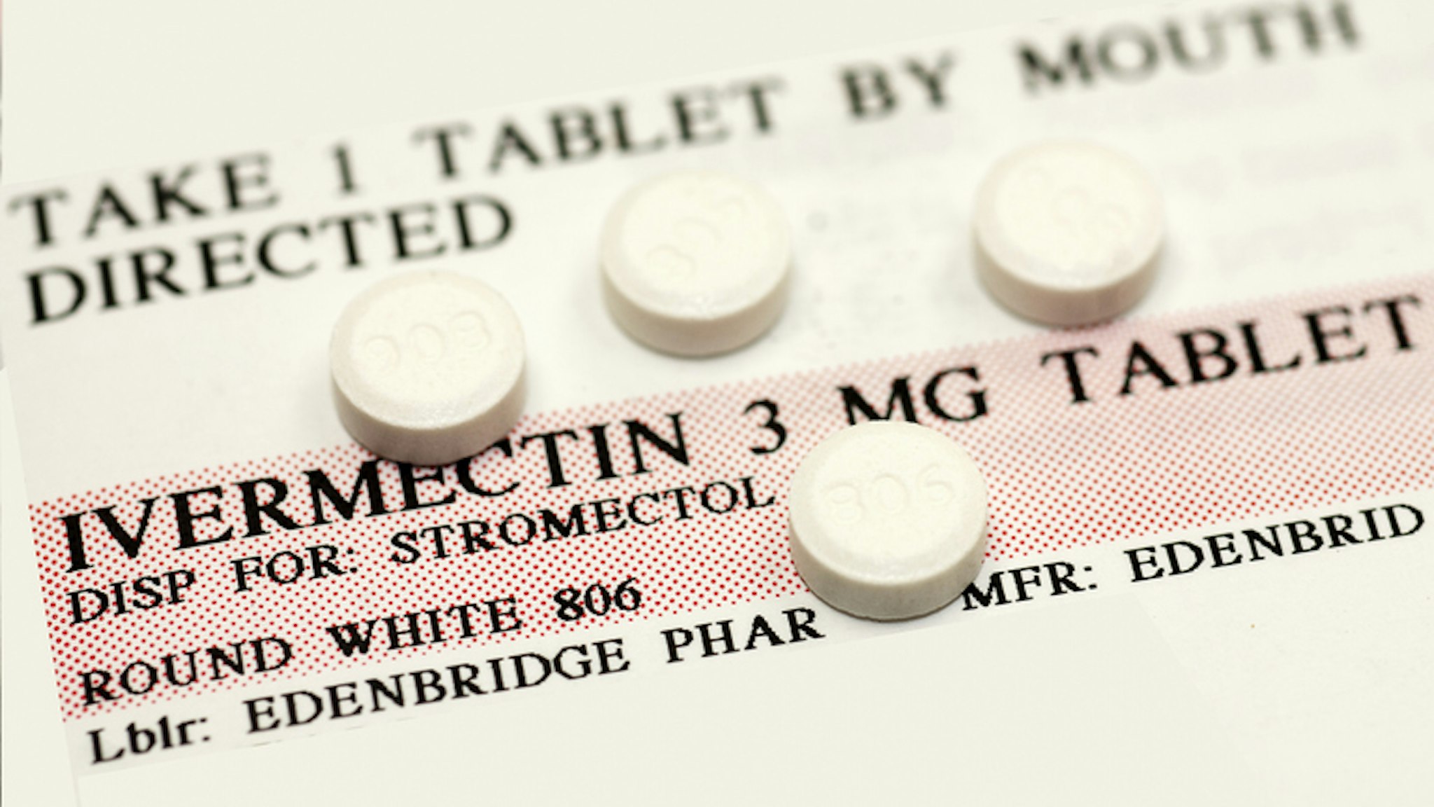 Ivermectin pills (a broad-spectrum antiparasitic agent) on top of instruction label