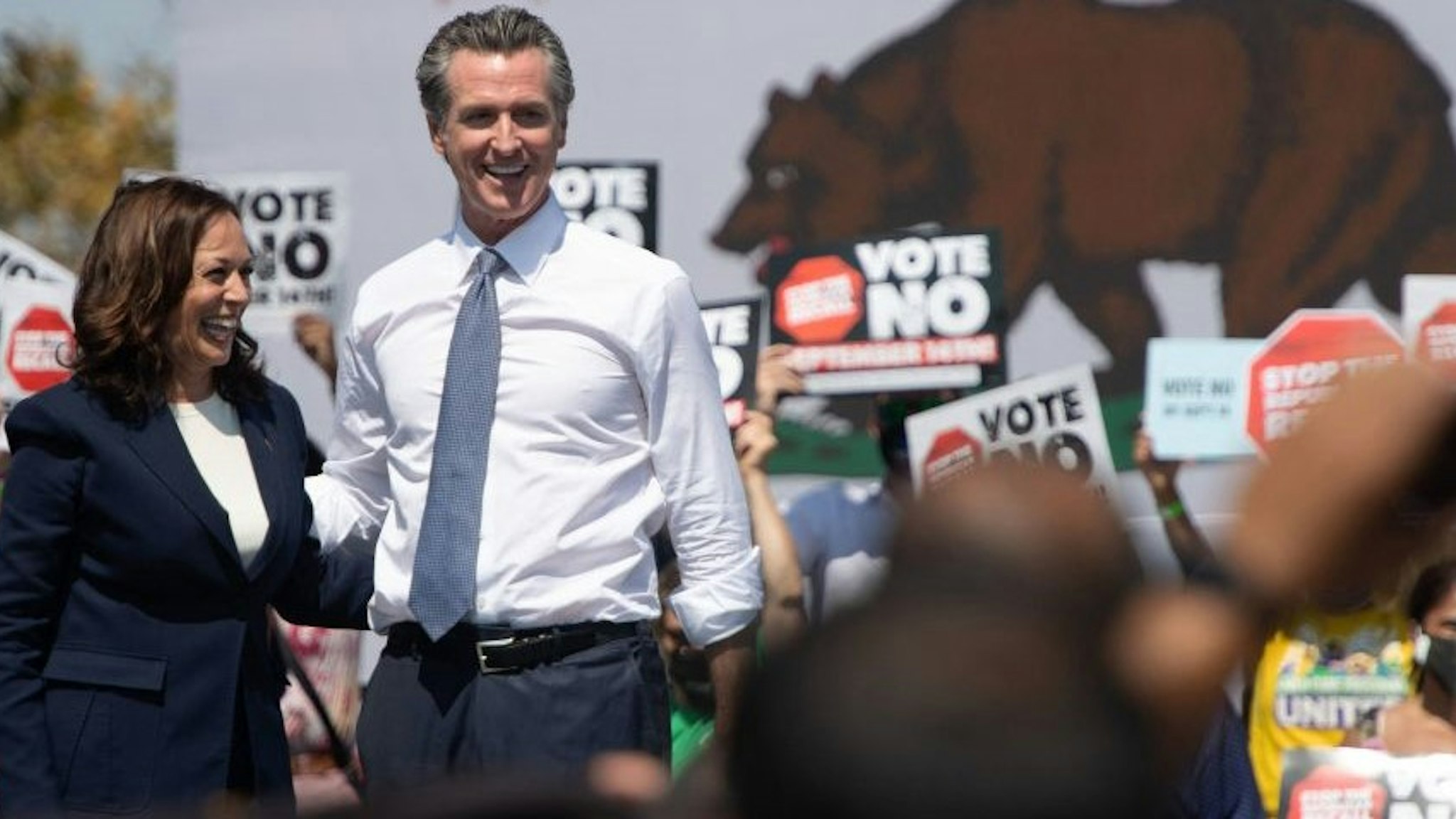 US Vice President Kamala Harris (L) stands with California Governor Gavin Newsom during a campaign event against his recall election at the IBEW-NECA Joint Apprenticeship Training Center in San Leandro, California, September 8, 2021. (Photo by SAUL LOEB / AFP) (Photo by