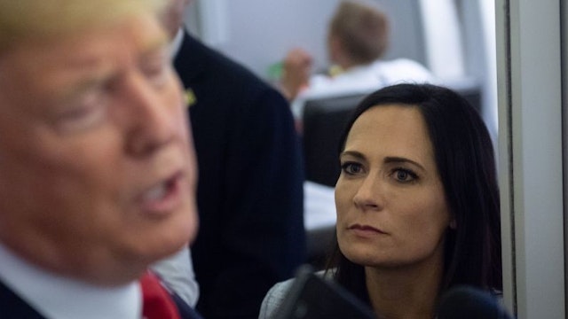 White House Press Secretary Stephanie Grisham listens as US President Donald Trump speaks to the media aboard Air Force One while flying between El Paso, Texas and Joint Base Andrews in Maryland, August 7, 2019. (Photo by SAUL LOEB / AFP) (Photo credit should read