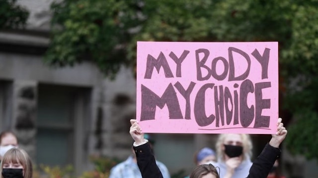 A demonstrator holds a placard saying "My Body My Choice" as... BLOOMINGTON, INDIANA, UNITED STATES - 2021/10/02: A demonstrator holds a placard saying "My Body My Choice" as they gather at the Sample Gates at Indiana University to rally in support of womens reproductive rights, in Bloomington. Women and their supporters rallied and marched in cities across the United States ahead of the United States Supreme Court reconvening October 4. A new law in Texas recently banned abortions after 6 weeks, which is before most women know they are pregnant. (Photo by Jeremy Hogan/SOPA Images/LightRocket via Getty Images) SOPA Images / Contributor