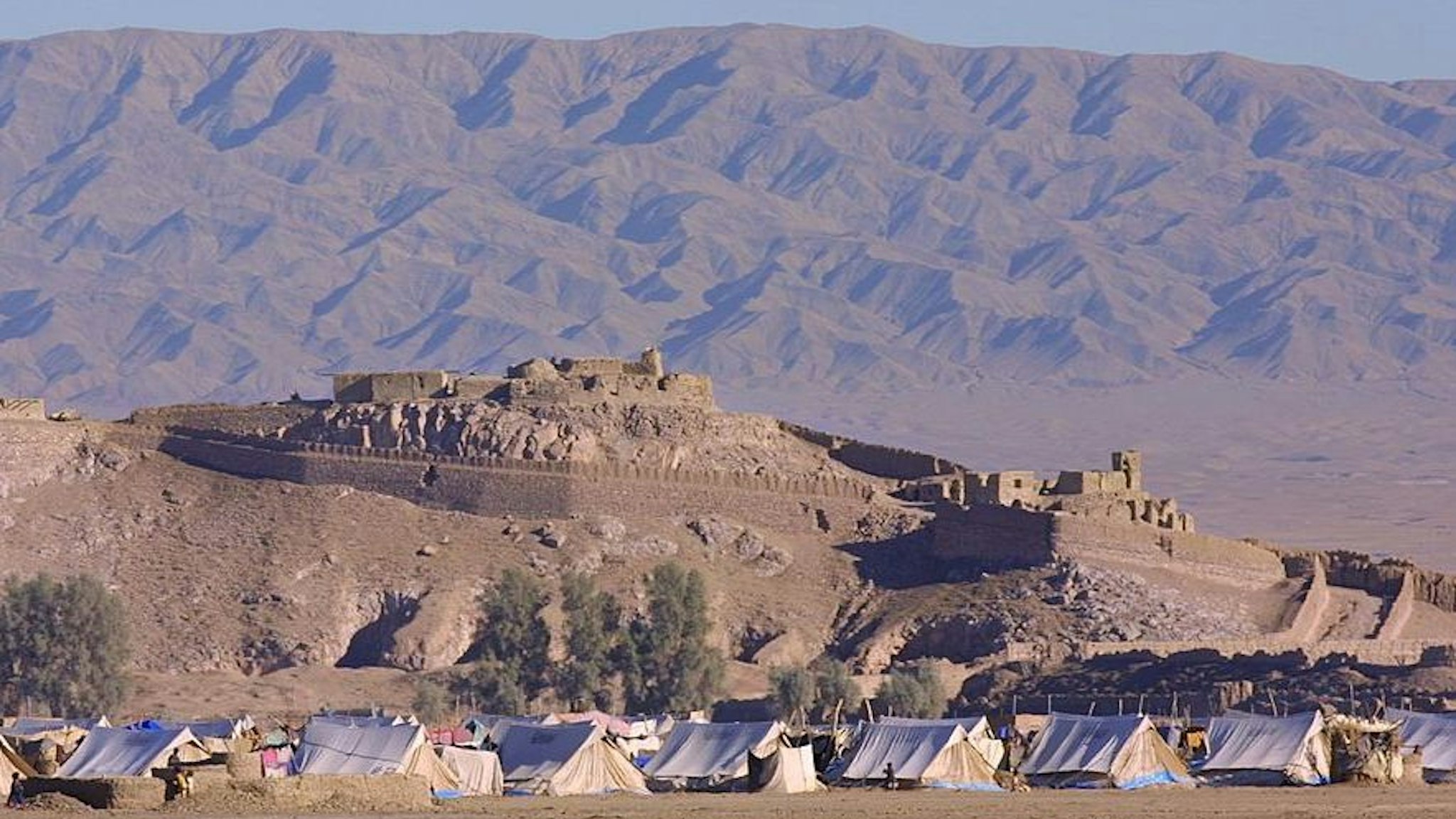 AFGHANISTAN - DECEMBER 01: Kandahar Road On January 12Th, 2001, Afghanistan. Afghan Refugee Camp Near The City Of Spin Boldak. In The Background, Pakistan Mountains.