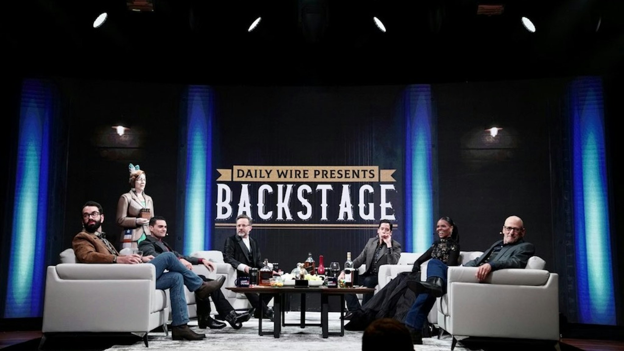 October 12: (L-R) The Daily Wire's Matt Walsh, Ben Shapiro, Jeremy Boreing, Michael Knowles, Candace Owens, and Andrew Klavan appear live at the Ryman Auditorium in Nashville for "Backstage Live at the Ryman." (Credit: The Daily Wire)