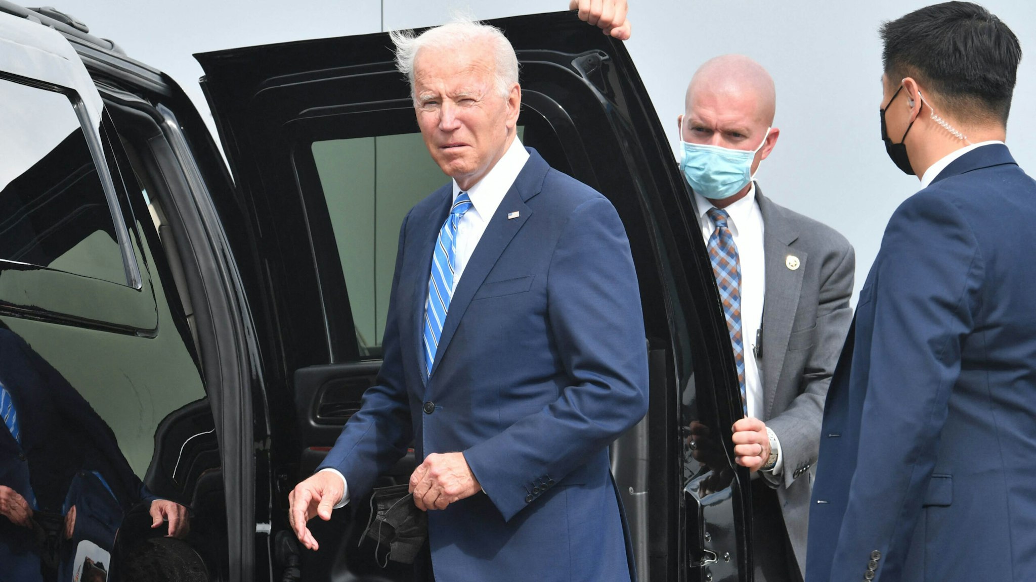 US President Joe Biden looks on after arriving on Airforce One at Chicago OHare International Airport in Chicago, Illinois on October 7, 2021, as he travels to promote the importance of Covid-19 vaccine requirements.