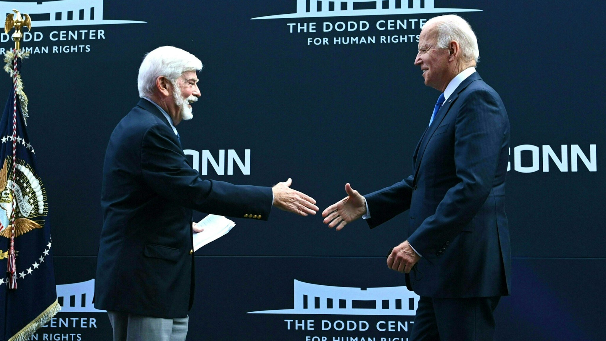 Former US Senator Chris Dodd (D-CT) greets US President Joe Biden (R) at the dedication of the Dodd Center for Human Rights at the University of Connecticut on October 15, 2021 in Storrs, Connecticut.
