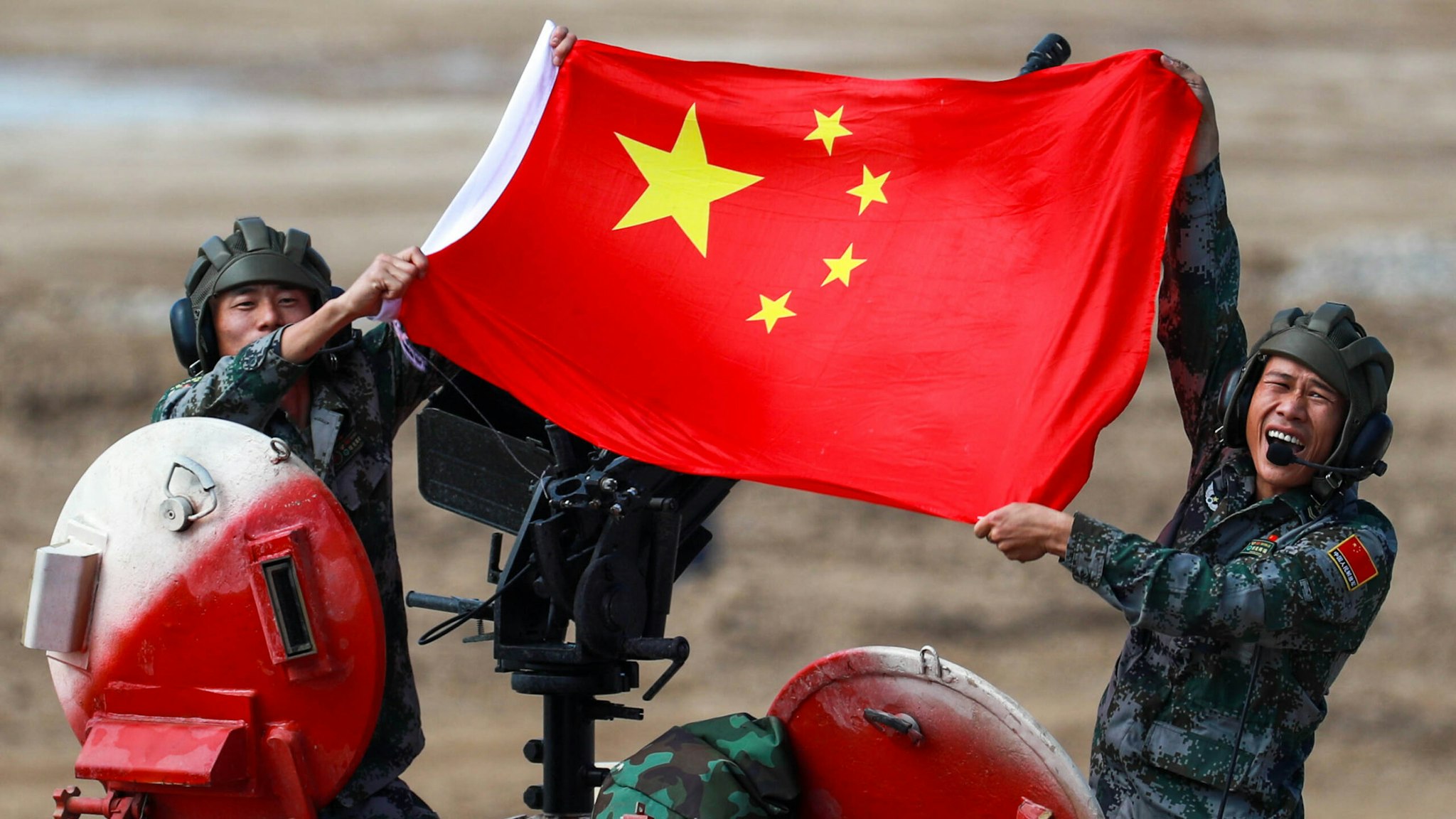 MOSCOW REGION, RUSSIA - AUGUST 28, 2021: People's Liberation Army (PLA) soldiers pose with a Chinese flag on a TYPE 96B tank during the Tank Biathlon Contest at the 2021 International Army Games at a military training ground in Alabino, Moscow Region. This year, 19 teams which are divided into two divisions, are competing in the contest.