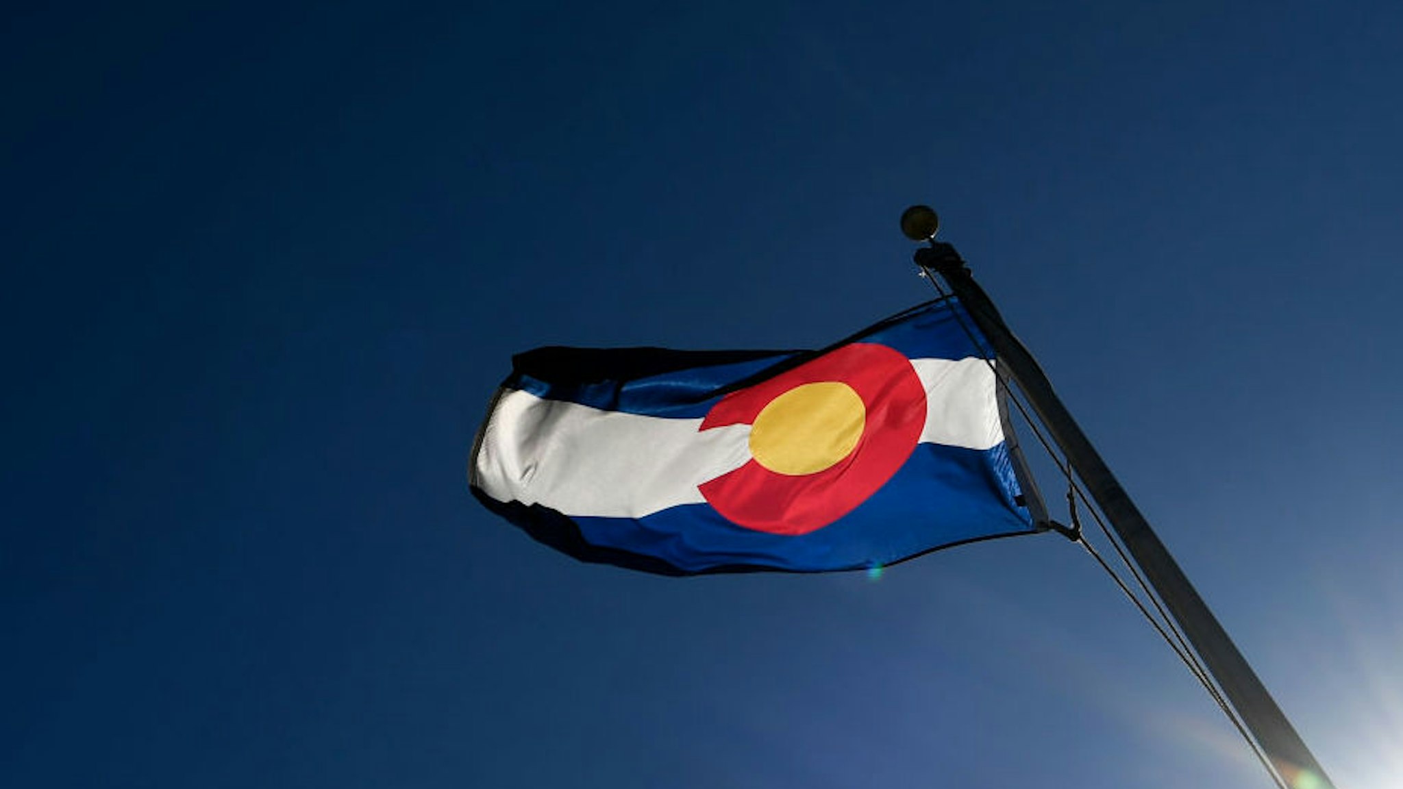 WESTMINSTER, CO - MARCH 5: The Colorado state flag blows stiffly near Federal Blvd. and 96th Ave. during a wind storm on Friday, March 5, 2018. Wind speed were in excess of 60 miles per hour in places near the Wyoming-Colorado border.