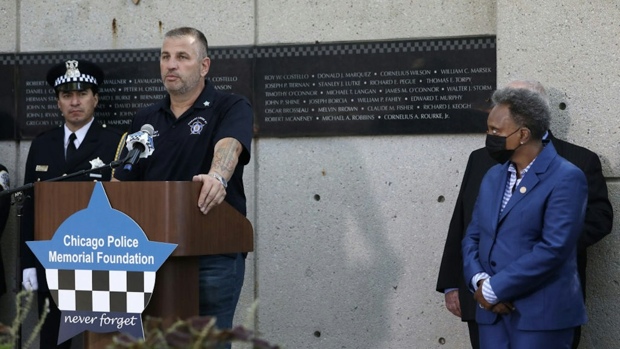 US-NEWS-CORONAVIRUS-CHICAGO-POLICE-TB John Catanzara, president of the Chicago Fraternal Order of Police Lodge 7, addresses attendees as Mayor Lori Lightfoot watches during the unveiling of names for five Chicago police officers at the Gold Star Families Memorial and Park in September. Four of the officers died of COVID-19 symptoms in 2020, and Officer Ella French was fatally shot on Aug. 7, during a traffic stop while on patrol. (John J. Kim/Chicago Tribune/Tribune News Service via Getty Images) Chicago Tribune / Contributor