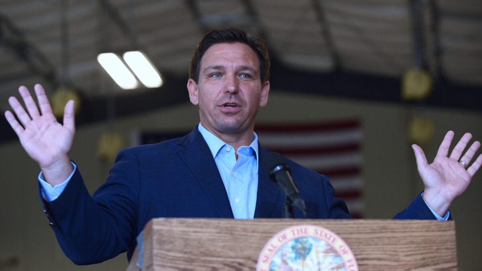 Florida Governor, Ron DeSantis speaks at a press conference at the Eau Gallie High School aviation hangar.