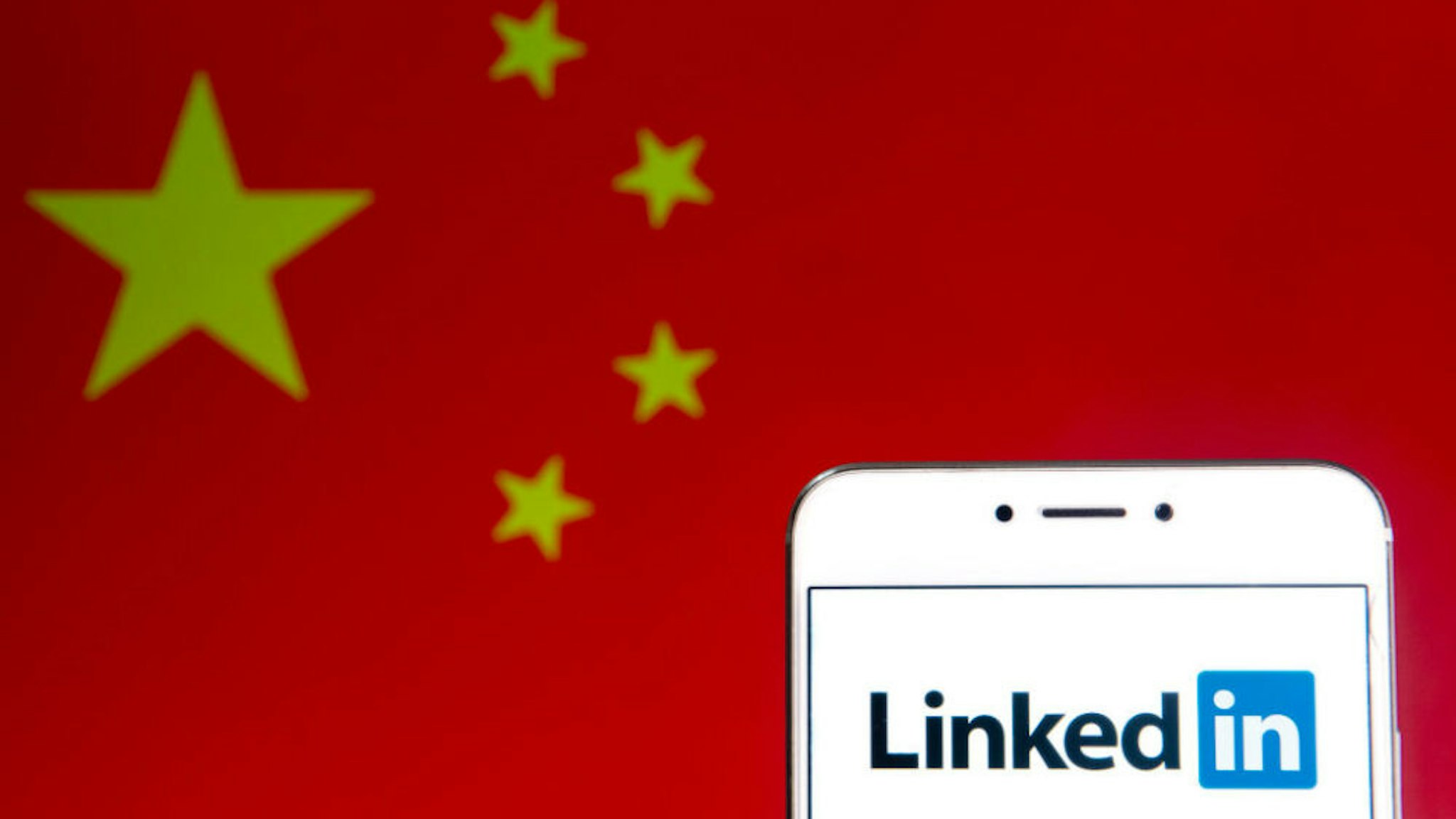 HONG KONG - 2019/04/06: In this photo illustration a business and employment oriented network and platform LinkedIn logo is seen on an Android mobile device with People's Republic of China flag in the background.