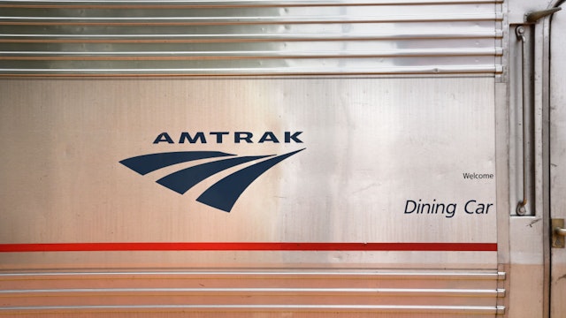 AMY, NEW MEXICO - MAY 19, 2019: The Amtrak logo on the side of the dining car of an Amtrak train stopped at the railroad depot in Lamy, New Mexico, near Santa Fe. Amtrak's Southwest Chief, which transports passengers between Chicago and Los Angeles, makes daily stops at the small Lamy station to pick up and discharge passengers. (Photo by Robert Alexander/Getty Images)