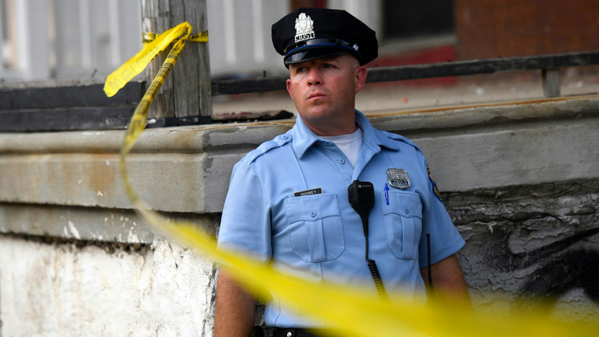 PHILADELPHIA, PA - AUGUST 14: A police officer monitors activity near a residence while responding to a shooting on August 14, 2019 in Philadelphia, Pennsylvania. At least six police officers were reportedly wounded in an hours-long standoff with a gunman that prompted a massive law enforcement response in the city's Nicetown-Tioga neighborhood. (Photo by Mark Makela/Getty Images)