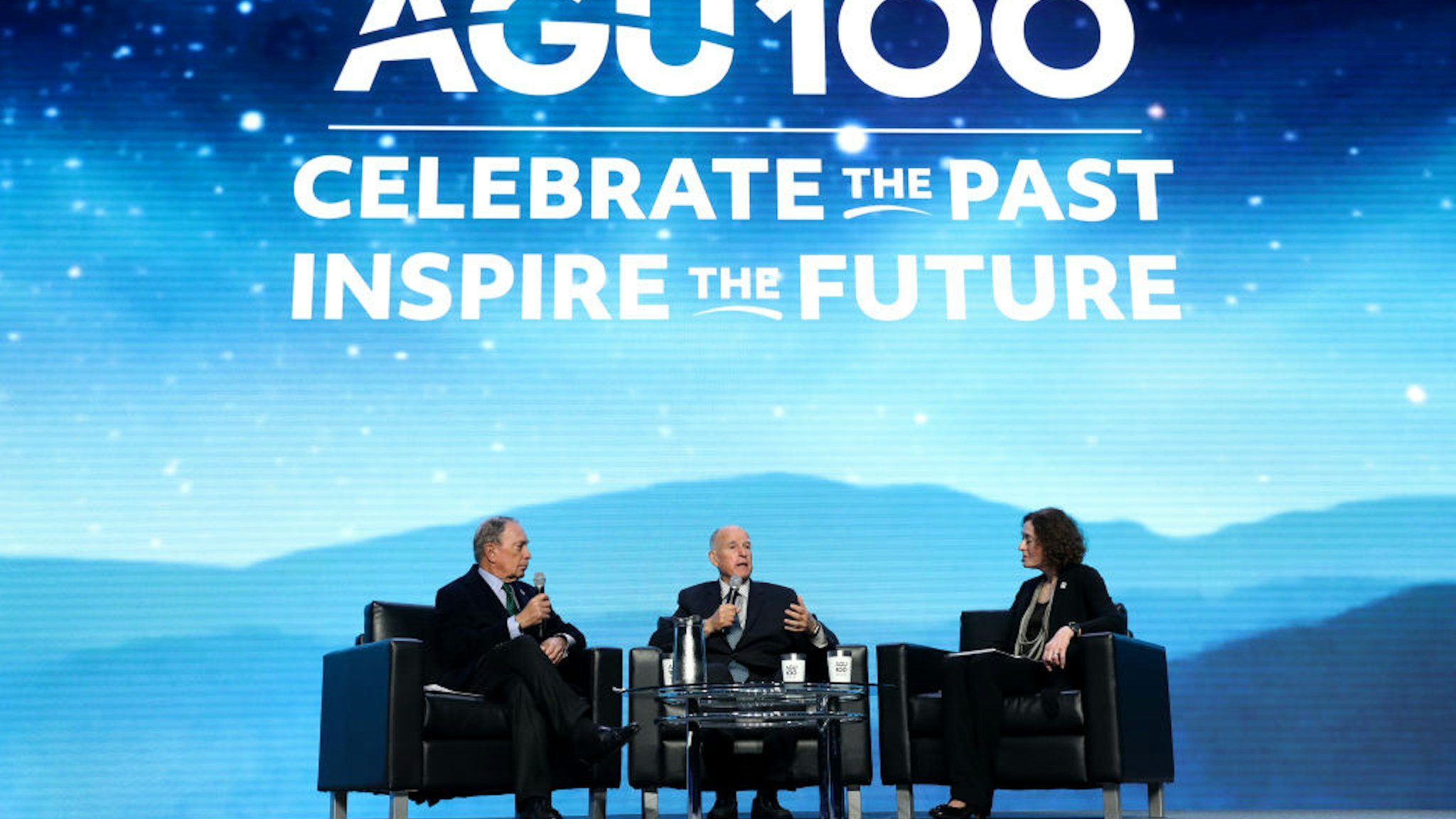 Democratic presidential candidate former New York City mayor Michael Bloomberg (L) and former California Gov. Jerry Brown (C) speak about climate change with AGU executive director and CEO Chris McEntee (R) during the American Geophysical Union Conference on December 11, 2019 in San Francisco, California.
