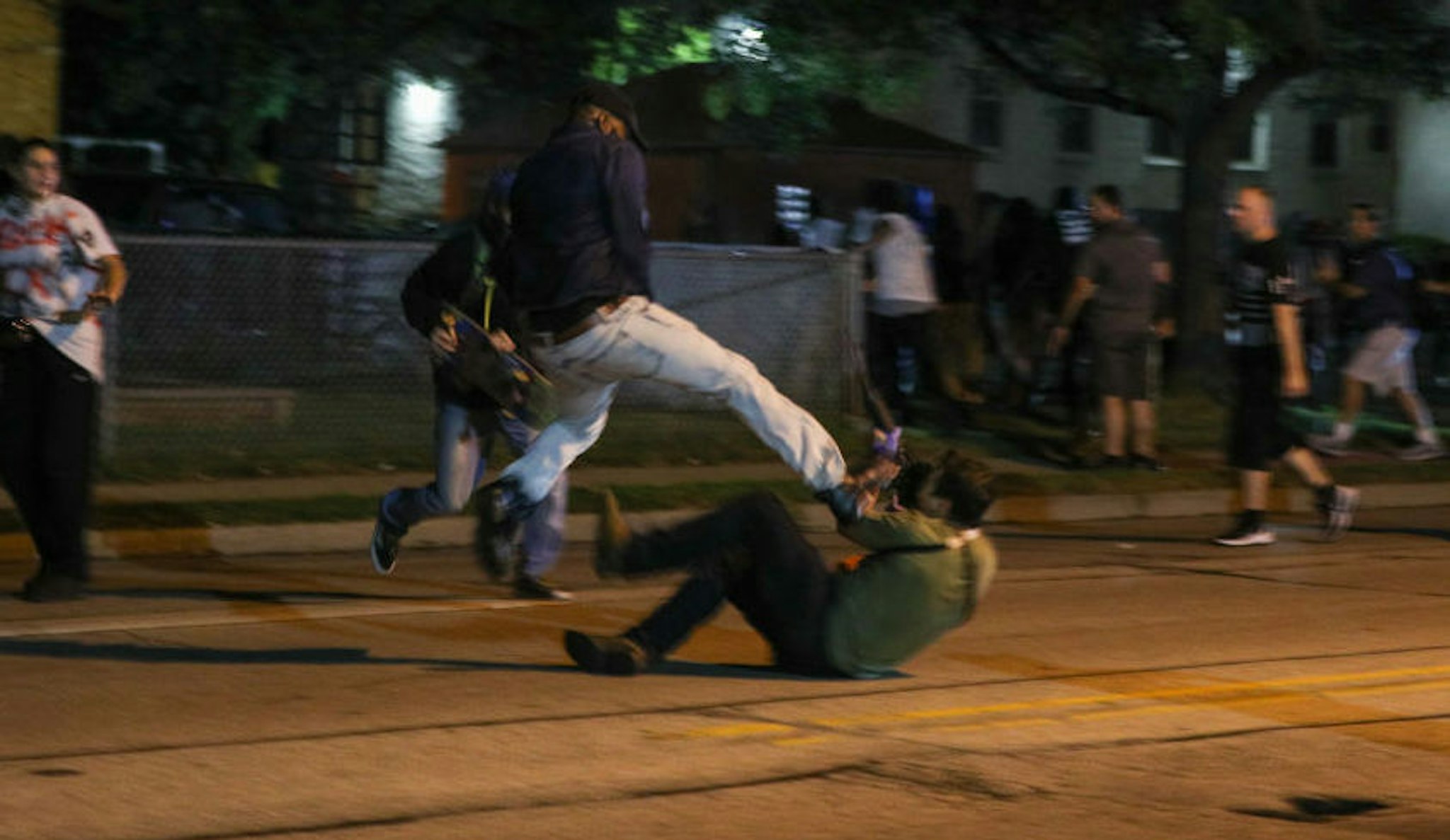A protester clashes with armed civilian Kyle Rittenhouse during confrontations between protesters and armed civilians, who claimed to protect the streets of Kenosha against the arson, during the third day of protests over the shooting of a black man Jacob Blake by police officer in Wisconsin, United States on August 25, 2020.