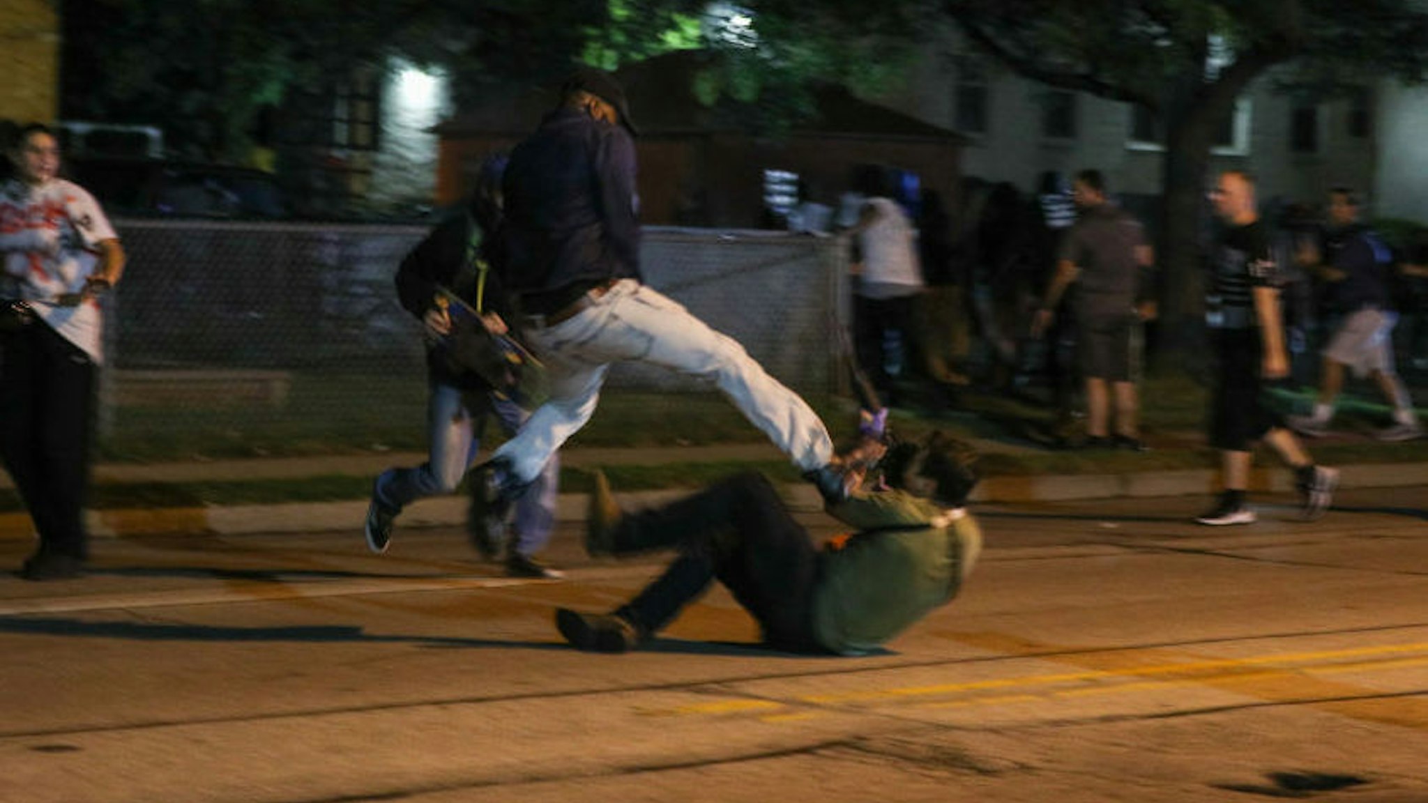 A protester clashes with armed civilian Kyle Rittenhouse during confrontations between protesters and armed civilians, who claimed to protect the streets of Kenosha against the arson, during the third day of protests over the shooting of a black man Jacob Blake by police officer in Wisconsin, United States on August 25, 2020.