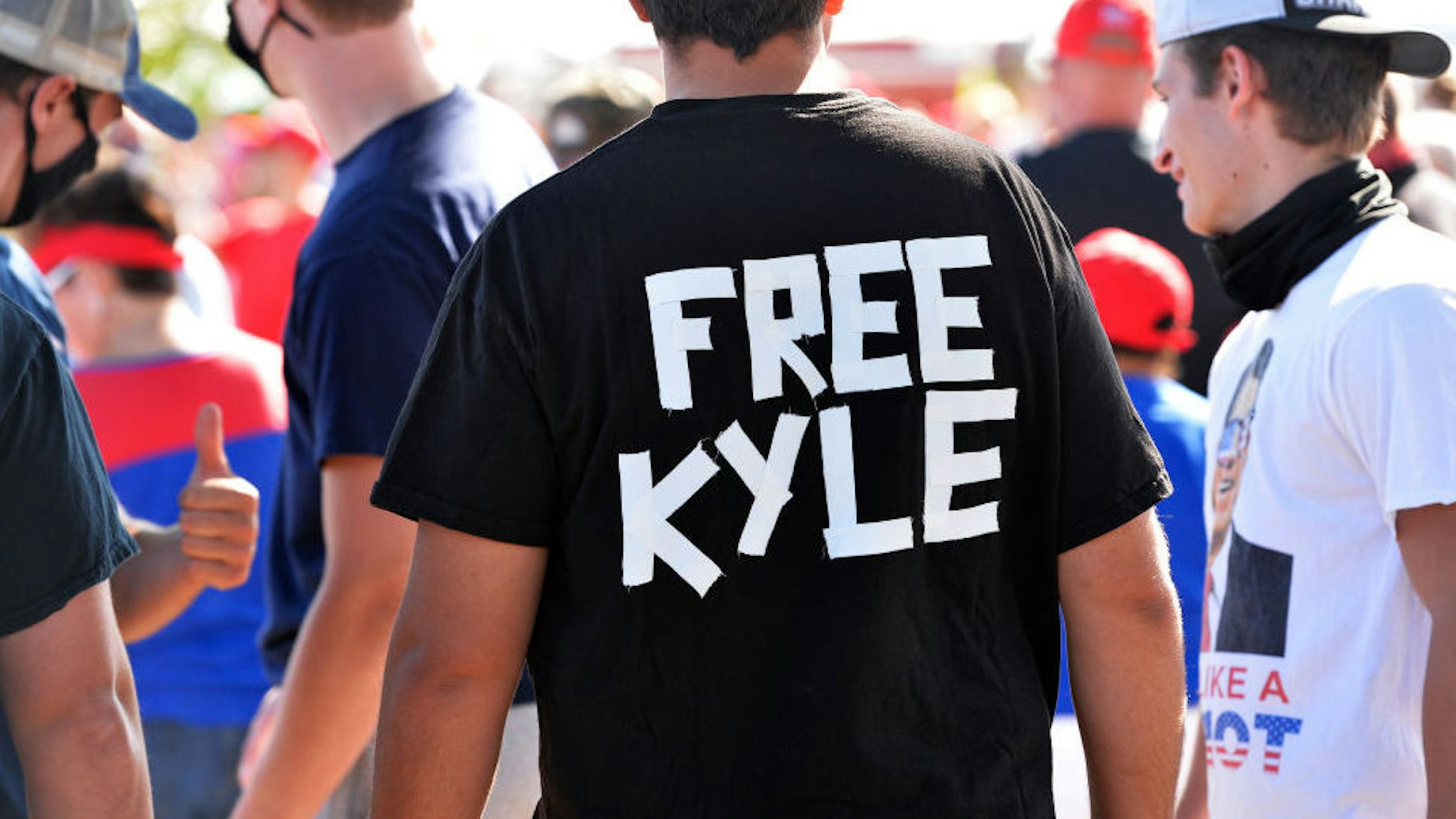 A man wears a shirt calling for freedom for Kyle Rittenhouse, 17, the man who allegedly shot protesters in Wisconsin, during a US President Donald Trump Campaign Rally, the day after the end of the Republican National Convention, at Manchester airport in Londonderry, New Hampshire on August 28, 2020.