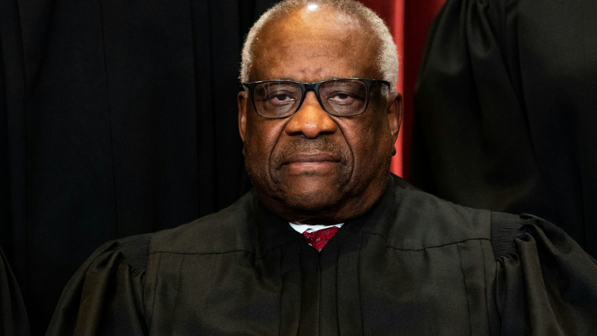 Associate Justice Clarence Thomas sits during a group photo of the Justices at the Supreme Court in Washington, DC on April 23, 2021.