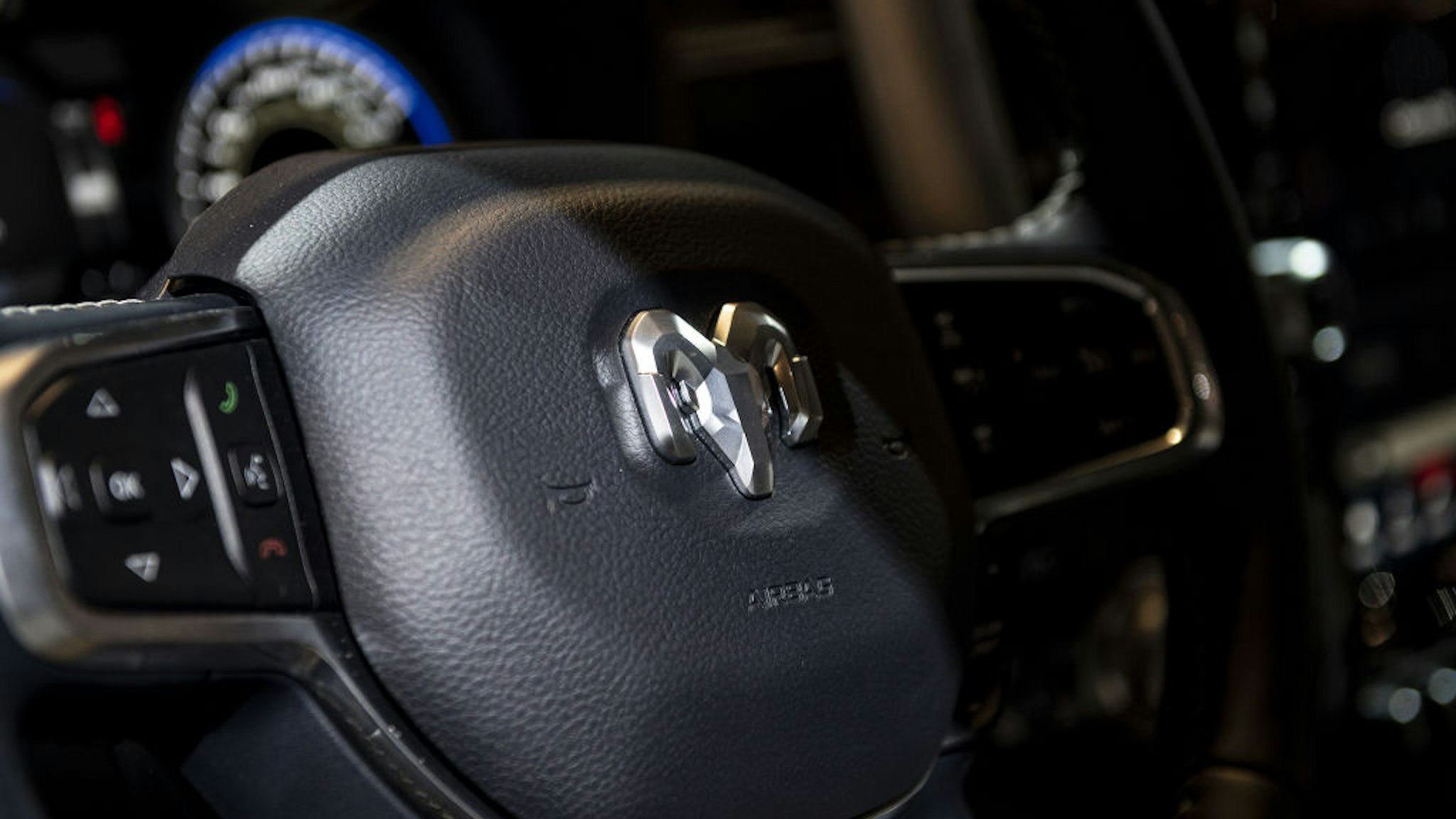 The steering wheel of a Fiat Chrysler Automobiles NV Dodge Ram TRX pickup truck during the media preview for the Chicago Auto Show in Chicago, Illinois, U.S., on Wednesday, July 14, 2021. The Chicago Auto Show marks not only the resumption of the largest U.S. auto show, but also heralds the return of those crowded industry conventions, and the tourist and tax dollars they bring. Photographer: Christopher Dilts/Bloomberg via Getty Images