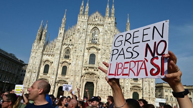 Protesters take part in a demonstration on Piazza Duomo in Milan on July 24, 2021, against the introduction of a mandatory 'green pass' for indoor dining and entertainment area, in the aim to limit the spread of the Covid-19. - Italy on July 22 said a health pass would be mandatory for people wishing to access bars, restaurants, swimming pools, sports facilities, museums and theatres from August 6. The rapid spread of the highly contagious Delta variant has fueled a surge in Covid-19 cases around the world this week, with total cases hitting 192,942,266 with 4,143,687 deaths. The placard reads "Green Pass No, Freedom Yes". (Photo by MIGUEL MEDINA / AFP) (Photo by MIGUEL MEDINA/AFP via Getty Images)