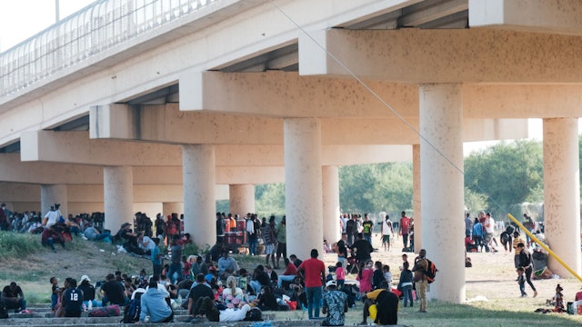 TEXAS, USA - SEPTEMBER 19: Migrants are seen at the Rio Grande near the Del Rio-Acuna Port of Entry in Del Rio, Texas, on September 18, 2021. - The United States said on September 18 that it would ramp up deportation flights for thousands of migrants who flooded into the Texas border city of Del Rio, as authorities scramble to alleviate a burgeoning crisis for President Joe Biden's administration. The migrants who poured into the city, many of them Haitian, were being held in an area controlled by US Customs and Border Protection (CBP) beneath the Del Rio International Bridge, which carries traffic across the Rio Grande river into Mexico. (Photo by Charlie C. Peebles/Anadolu Agency via Getty Images)