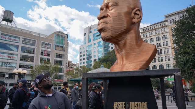 A man looks at a George Floyd statue as the Immersive art organization, Confront Art, in collaboration with the NYC Parks, unveils the SEENINJUSTICE exhibit, featuring three sculptures by Chris Carnabucci