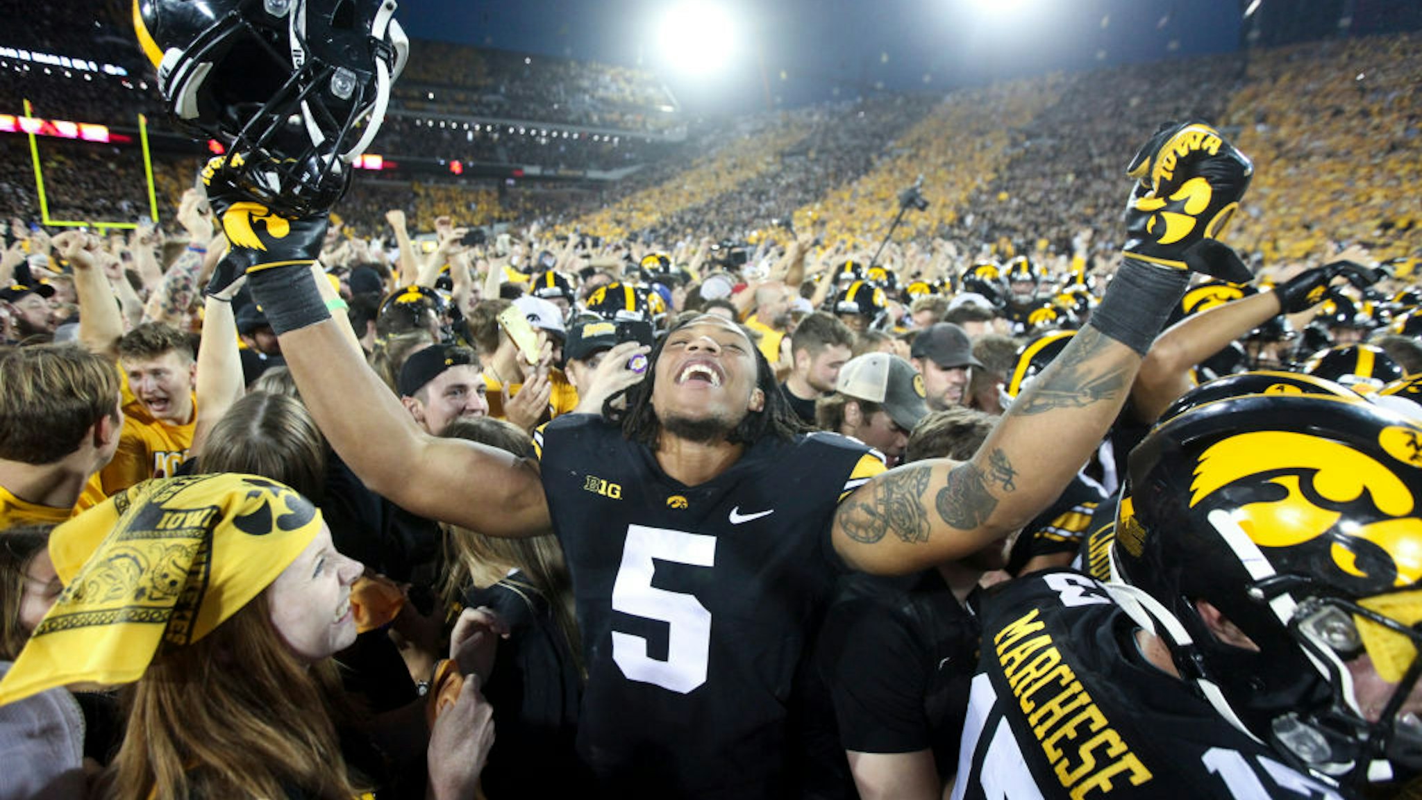 IOWA CITY, IOWA- OCTOBER 9: Linebacker Jestin Jacobs #5 of the Iowa Hawkeyes celebrates with fans after the match-up against the Penn State Nittany Lions at Kinnick Stadium on October 9, 2021 in Iowa City, Iowa. (Photo by Matthew Holst/Getty Images)