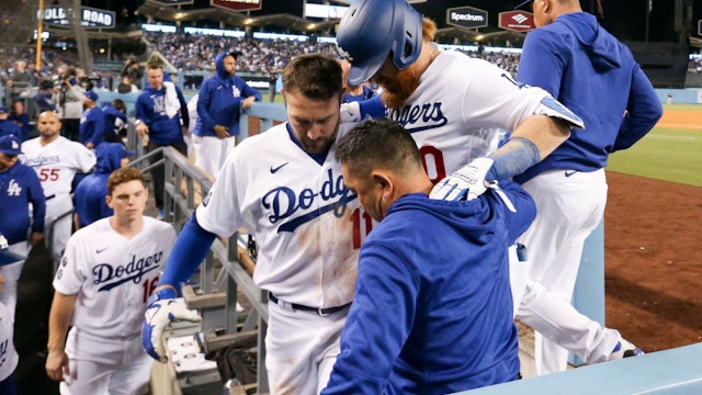 Los Angeles, CA - October 20: Los Angeles Dodgers' Justin Turner is helped into the dugout by AJ Pollock and staff after an apparent injury during the seventh inning in game four in the 2021 National League Championship Series against the Atlanta Braves at Dodger Stadium on Wednesday, Oct. 20, 2021 in Los Angeles, CA. (Robert Gauthier / Los Angeles Times via Getty Images)