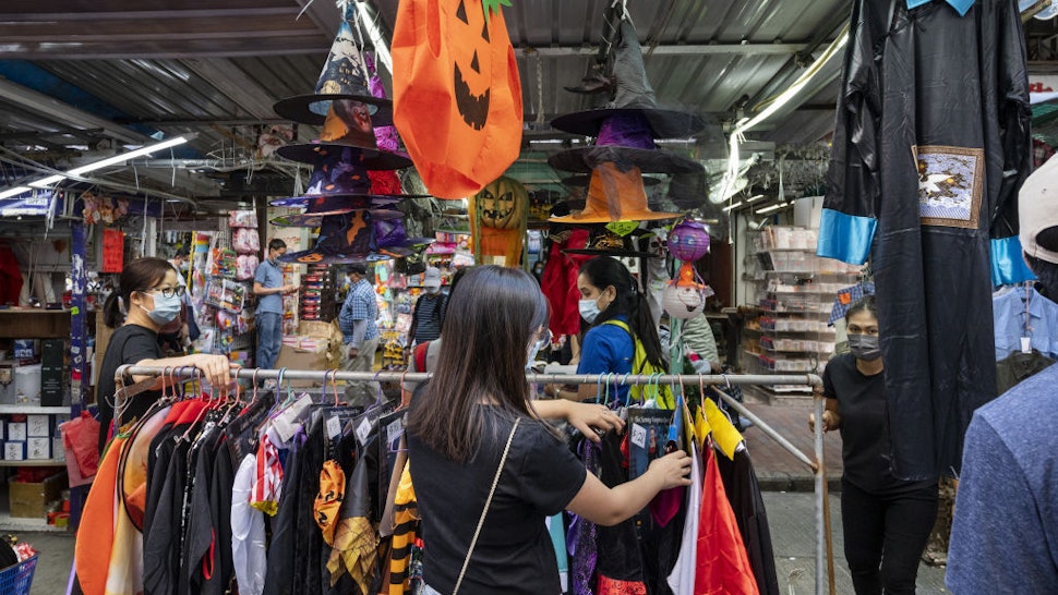 A customer is seen browsing for Halloween theme costumes at a stall days before Halloween in Hong Kong on October 25, 2021.