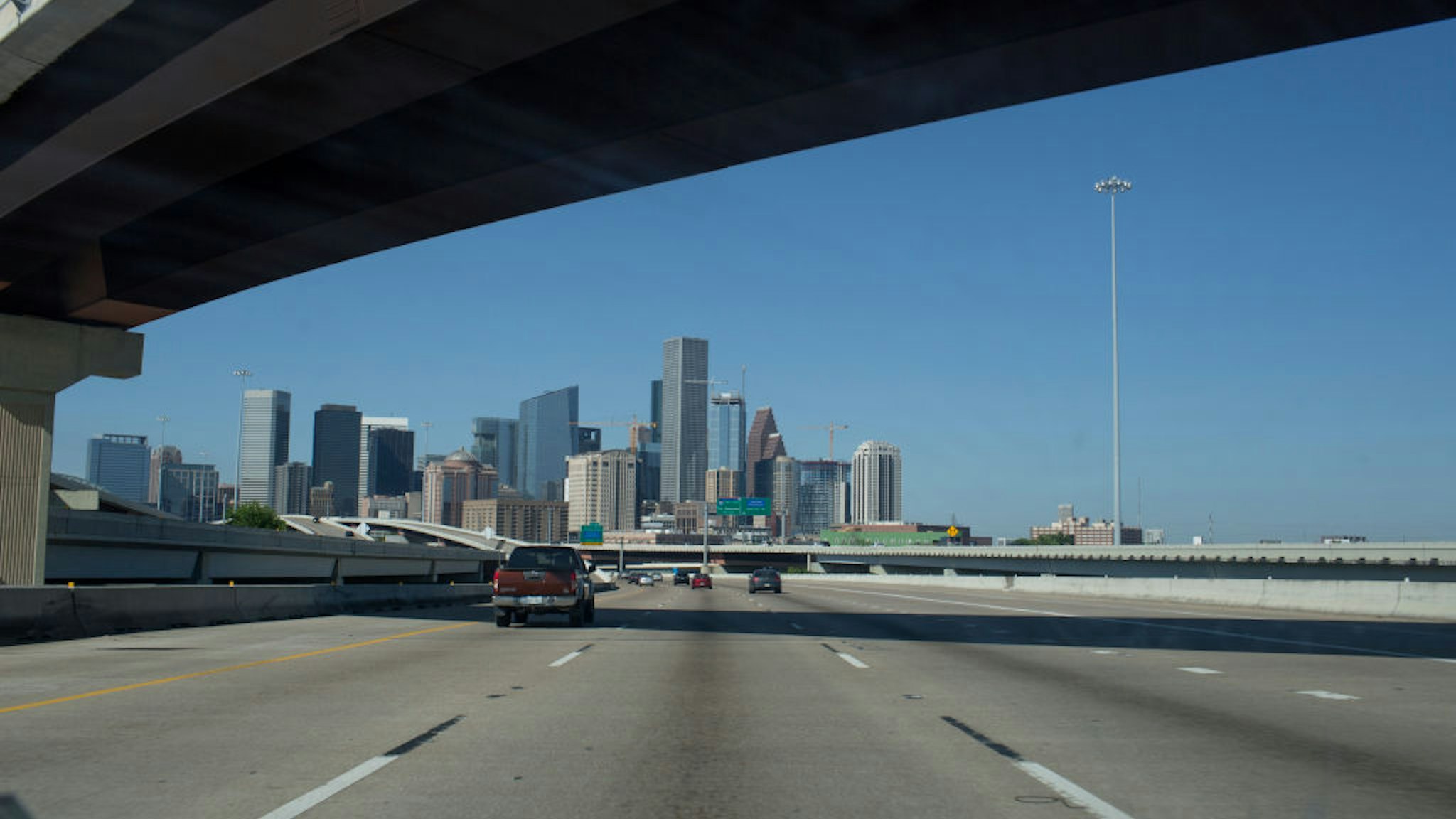 The Houston skyline appears above an intersection of freeways approaching from the east on April 11, 2021 in Houston, Texas.