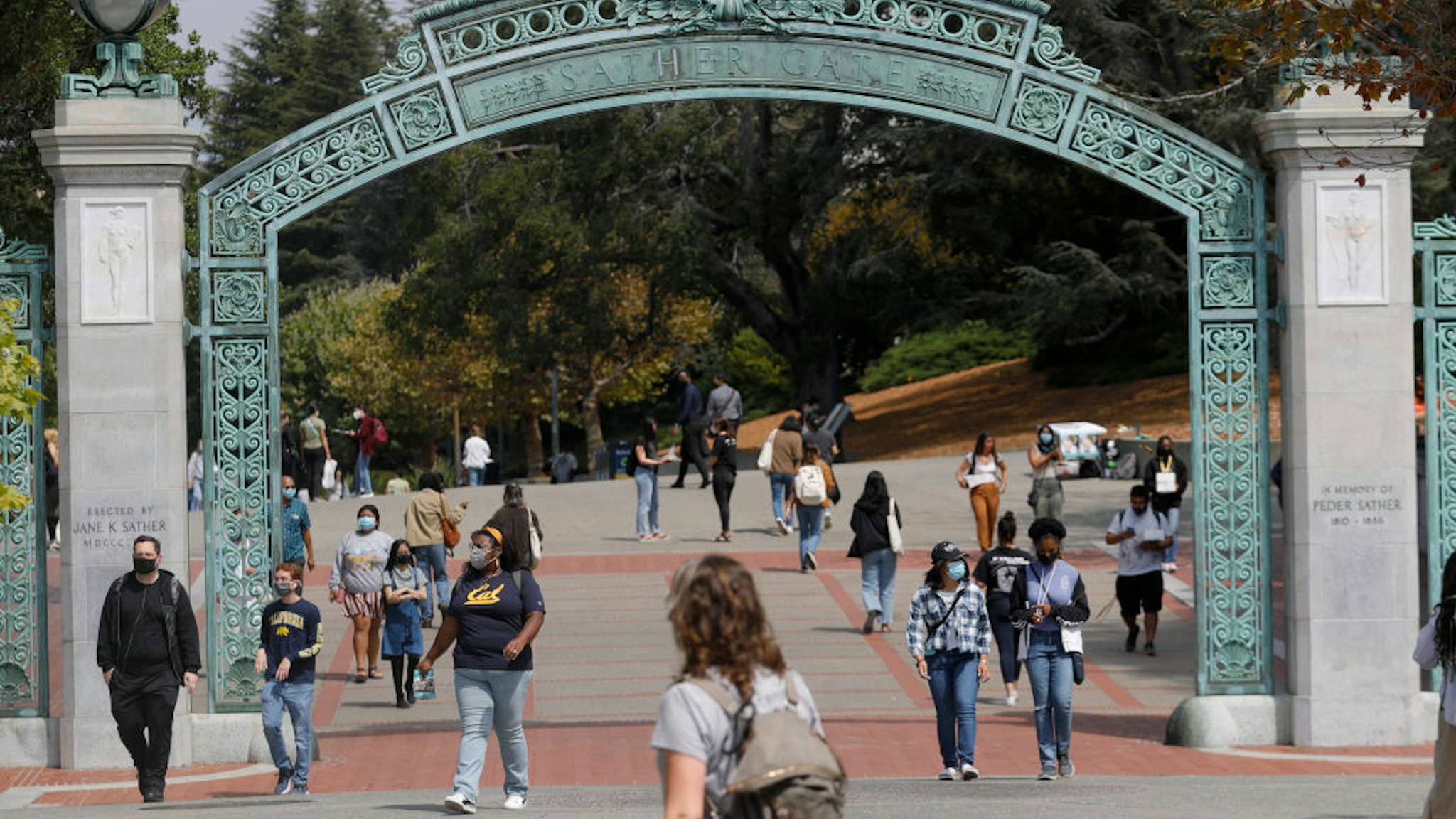 Students walk near the Sather Gate on the UC Berkeley campus in Berkeley, Calif., on Tuesday, August 24, 2021.