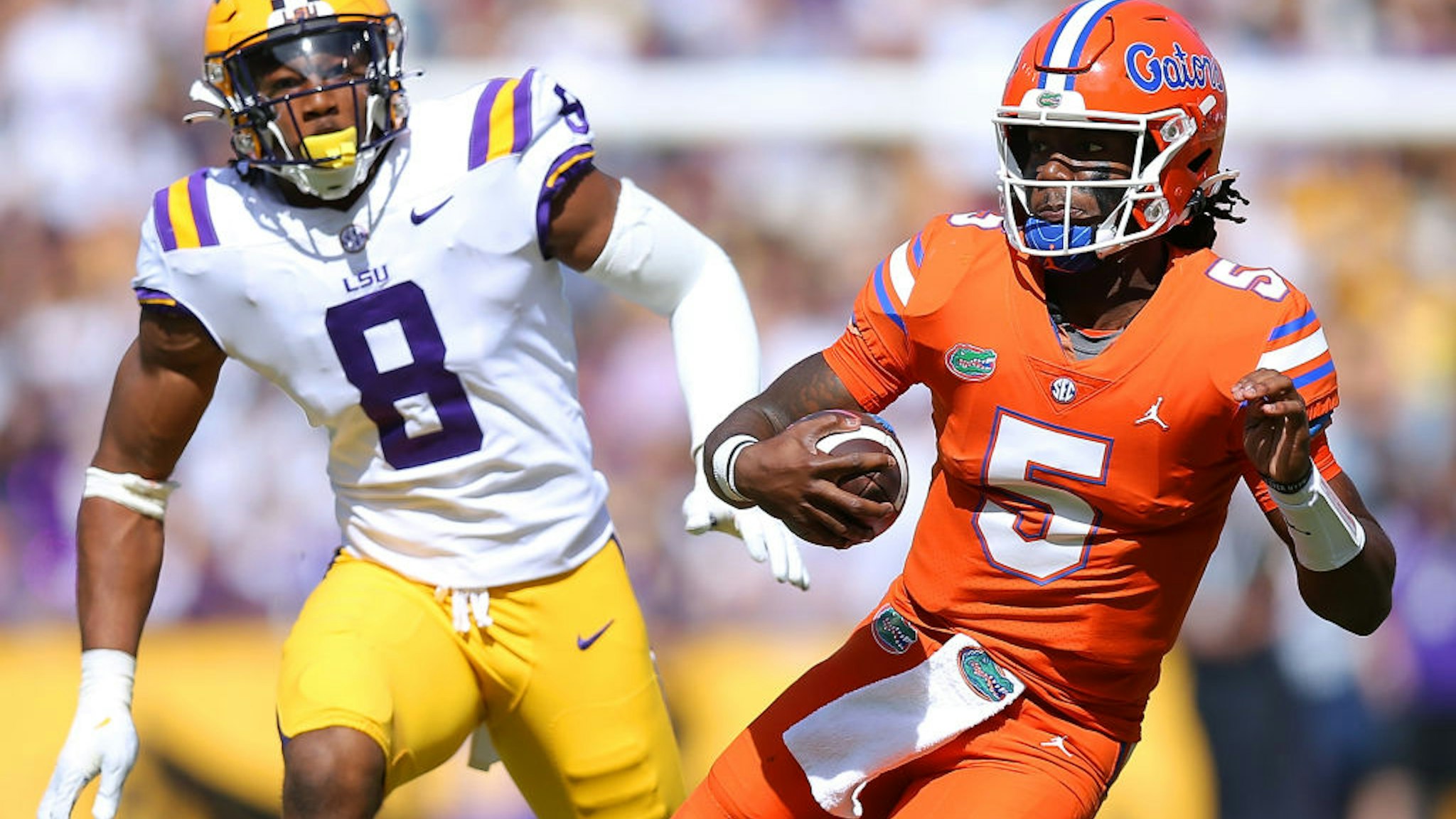 Emory Jones #5 of the Florida Gators runs with the ball as BJ Ojulari #8 of the LSU Tigers defends during the first half at Tiger Stadium on October 16, 2021 in Baton Rouge, Louisiana.