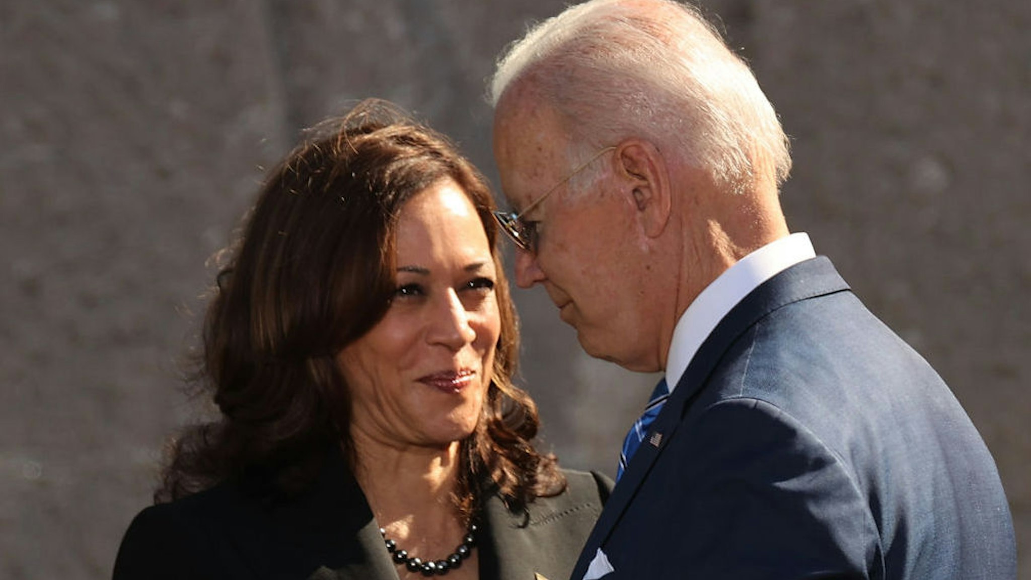 U.S. President Joe Biden (R) and Vice President Kamala Harris shake hands during the 10th-anniversary celebration of the Martin Luther King, Jr. Memorial near the Tidal Basin on the National Mall on October 21, 2021 in Washington, DC.