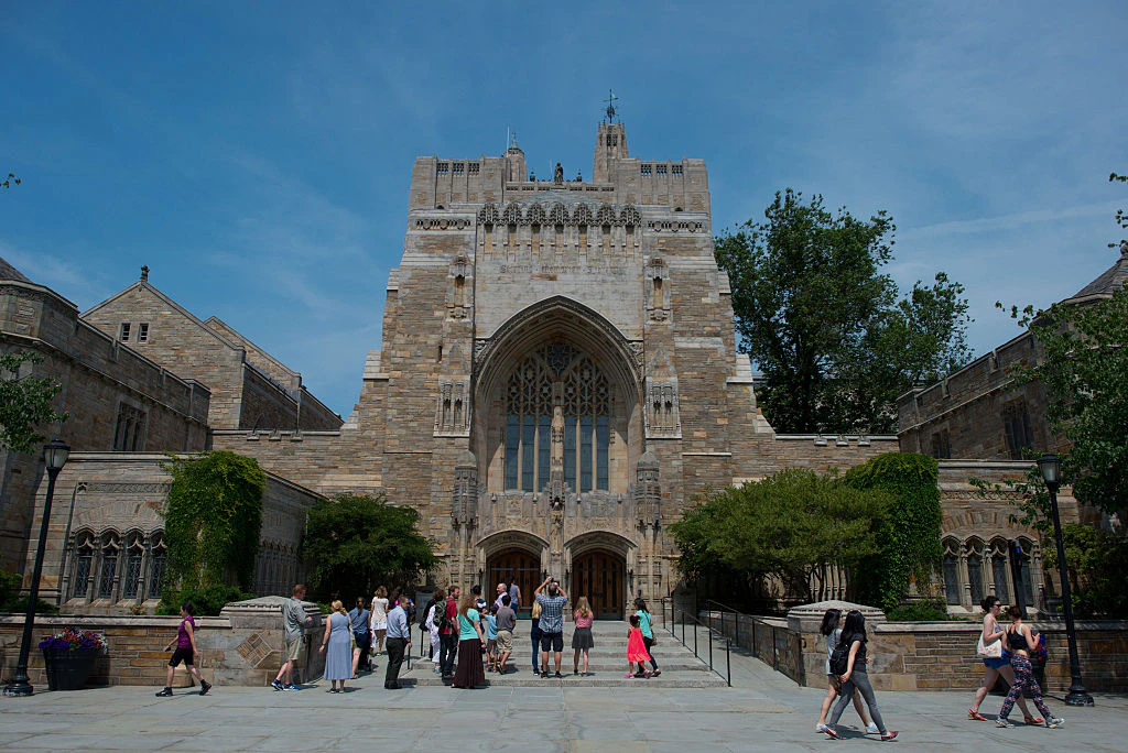 A tour group makes a stop at the Sterling Memorial Library on the Yale University campus in New Haven, Connecticut, U.S., on Friday, June 12, 2015.