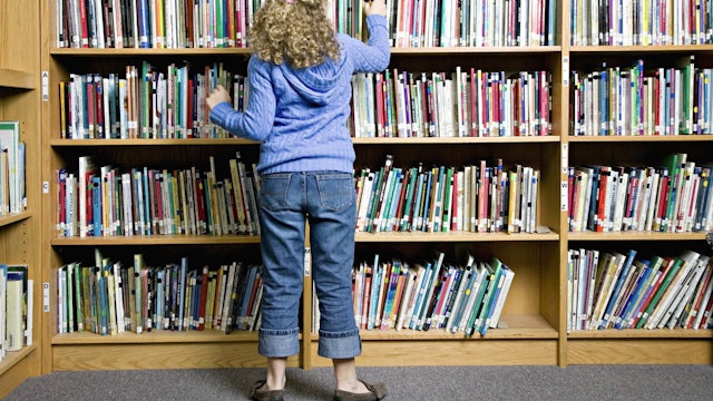 Girl Looking at Library Books