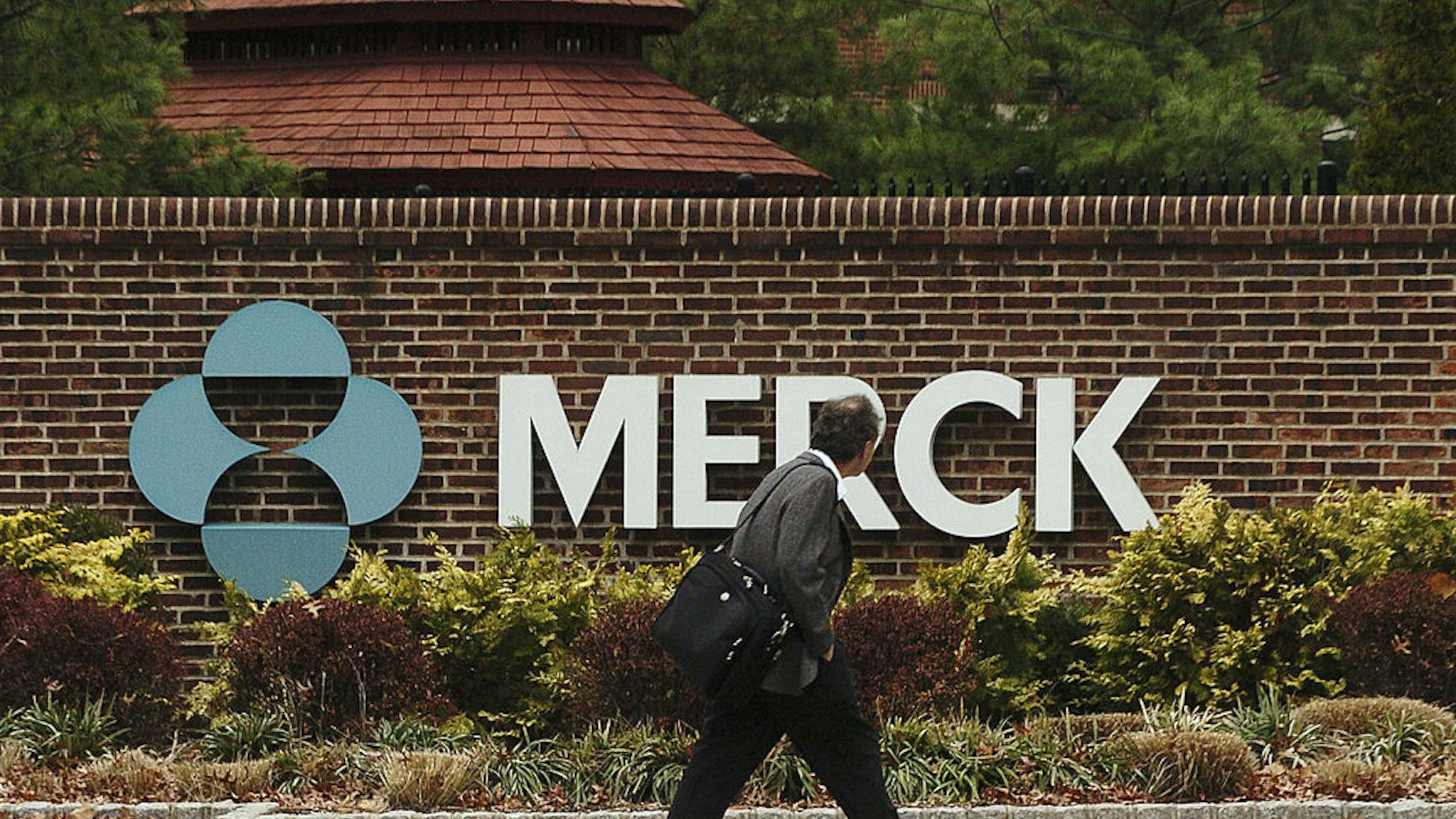 RAHWAY, NJ - NOVEMBER 29: A man walks by a sign at a Merck plant November 29, 2005 in Rahway, New Jersey. U.S. pharmaceutical giant Merck, announced plans to cut some 7,000 jobs, or 11 percent of its global workforce, by the end of 2008. (Photo by Marko Georgiev/Getty Images)