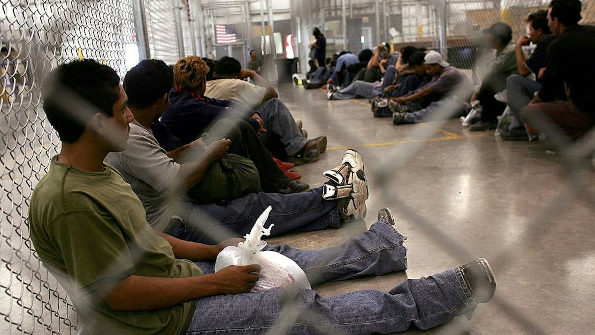 NOGALES, AZ - JUNE 21: Men who were caught crossing the U.S. border with Mexico illegally wait in a holding cell on June 21, 2006 at the U.S. Border Patrol processing center in Nogales, Arizona. U.S. President George W. Bush plans to deploy a total 6,000 National Guard soldiers in the four southern border states in an attempt to mitigate illegal immigration into America. Detentions along the U.S.-Mexico border decreased by 21 percent to 26,994, in the first 10 days of June according to U.S. authorities compared. (Photo by Spencer Platt/Getty Images)