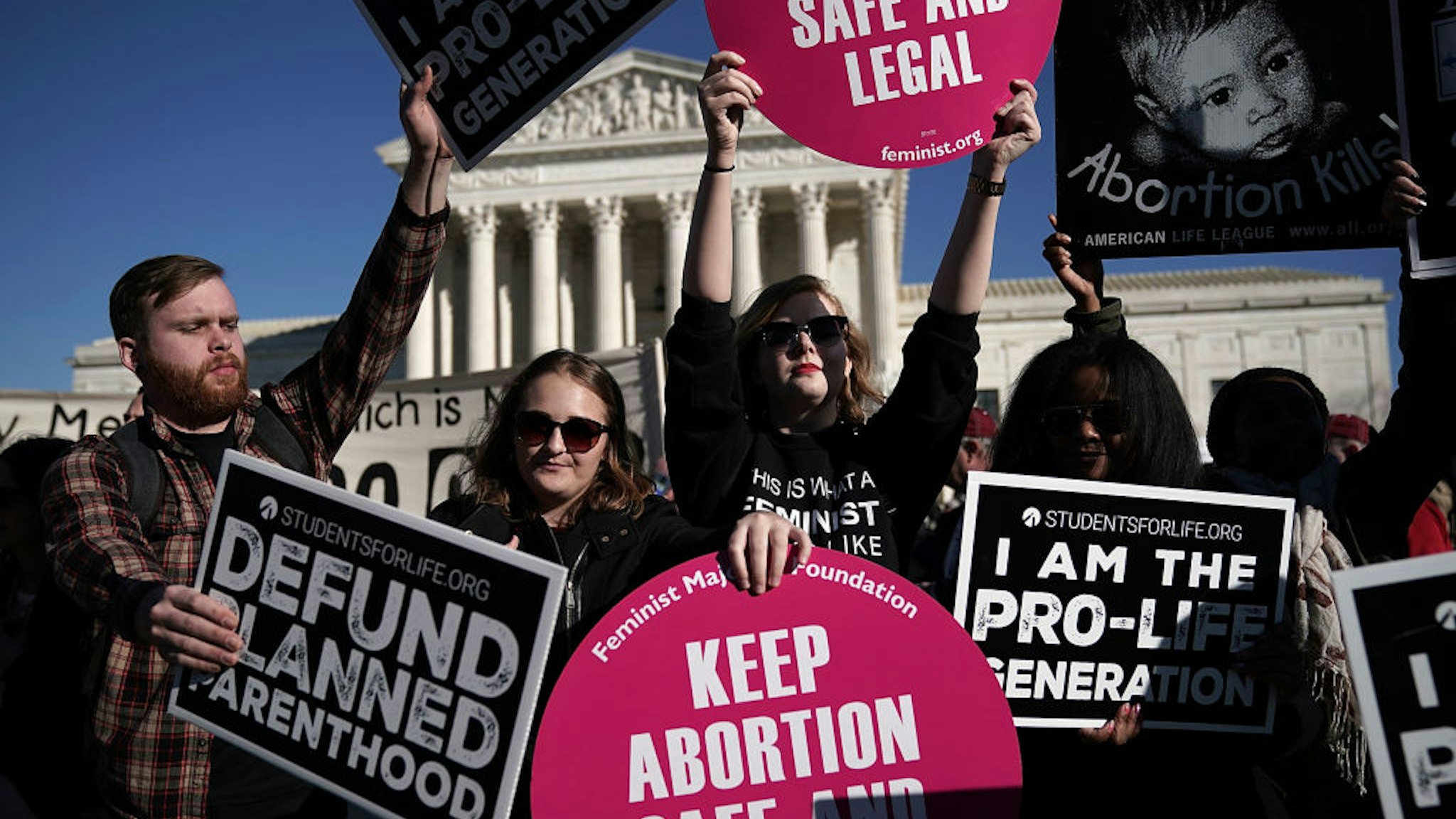 WASHINGTON, DC - JANUARY 19: Pro-life activists try to block the signs of pro-choice activists in front of the the U.S. Supreme Court during the 2018 March for Life January 19, 2018 in Washington, DC. Activists gathered in the nation's capital for the annual event to mark the anniversary of the Supreme Court Roe v. Wade ruling that legalized abortion in 1973. (Photo by Alex Wong/Getty Images)