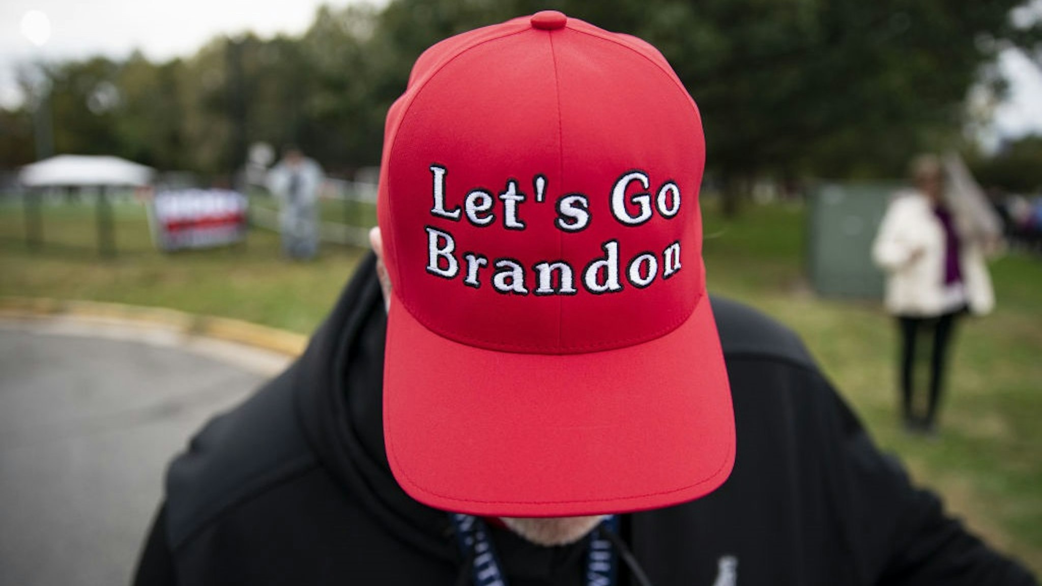 A supporter of former U.S. President Donald Trump displays a "Let's Go Brandon" hat before a campaign event for Terry McAuliffe, Democratic gubernatorial candidate for Virginia, in Arlington, Virginia,