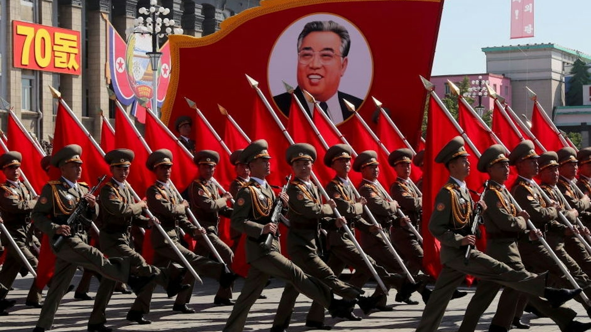 PYONGYANG, NORTH KOREA - SEPTEMBER 9, 2018: Servicemen carry a banner depicting Kim Il-sung, a former North Korean leader, during a parade in Pyongyang. Alexander Demianchuk/TASS