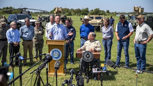 Pete Ricketts, governor of Nebraska, speaks beside Greg Abbott, governor of Texas, center right, during a news conference in Mission, Texas, U.S., on Wednesday, Oct. 6, 2021. Abbott and Republican state chief executives from around the nation gathered at the border to again call attention to unauthorized immigration across the Rio Grande.
