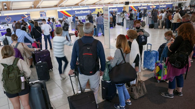 BALTIMORE, MARYLAND - OCTOBER 11: Travelers wait to check in at the Southwest Airlines ticketing counter at Baltimore Washington International Thurgood Marshall Airport on October 11, 2021 in Baltimore, Maryland. Southwest Airlines is working to catch up on a backlog after canceling hundreds of flights over the weekend, blaming air traffic control issues and weather.