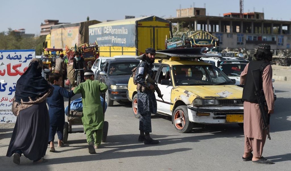 In this picture taken on October 3, 2021, Taliban fighters working as a police force check commuters at a road checkpoint in Kabul. - The Taliban's new police force already counts about 4,000 men in the capital, says a Kabul police spokesman, insisting the city is far safer than before, as the hardline group builds a police force from scratch. - TO GO WITH Afghanistan-police-Taliban,FOCUS by Elise BLANCHARD (Photo by WAKIL KOHSAR / AFP) / TO GO WITH Afghanistan-police-Taliban,FOCUS by Elise BLANCHARD (Photo by WAKIL KOHSAR/AFP via Getty Images)