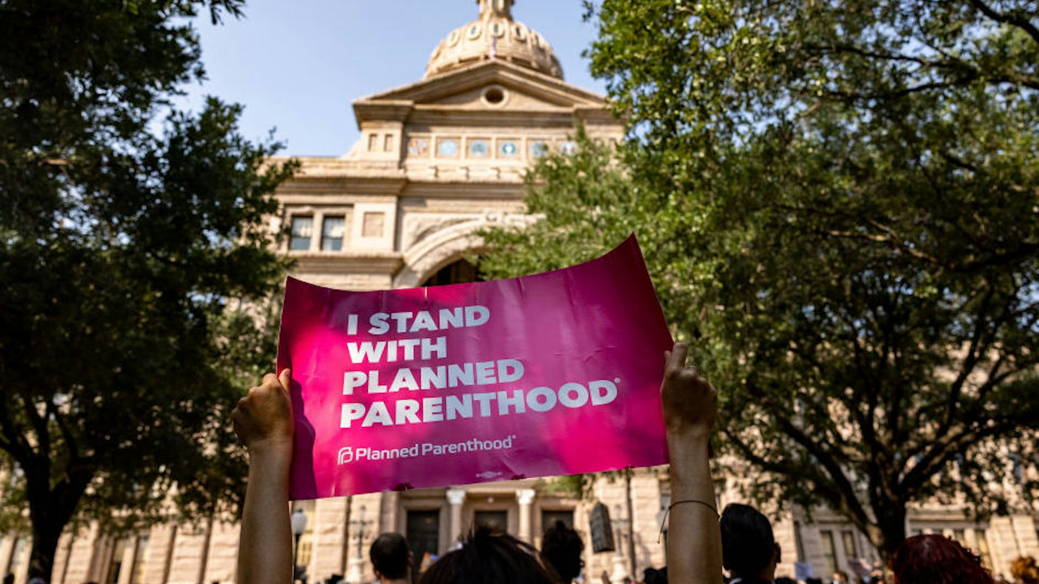 AUSTIN, TX - SEPTEMBER 11: An abortion rights activist holds a sign in support of Planned Parenthood at a rally at the Texas State Capitol on September 11, 2021 in Austin, Texas. Texas Lawmakers recently passed several pieces of conservative legislation, including SB8, which prohibits abortions in Texas after a fetal heartbeat is detected on an ultrasound, usually between the fifth and sixth weeks of pregnancy.