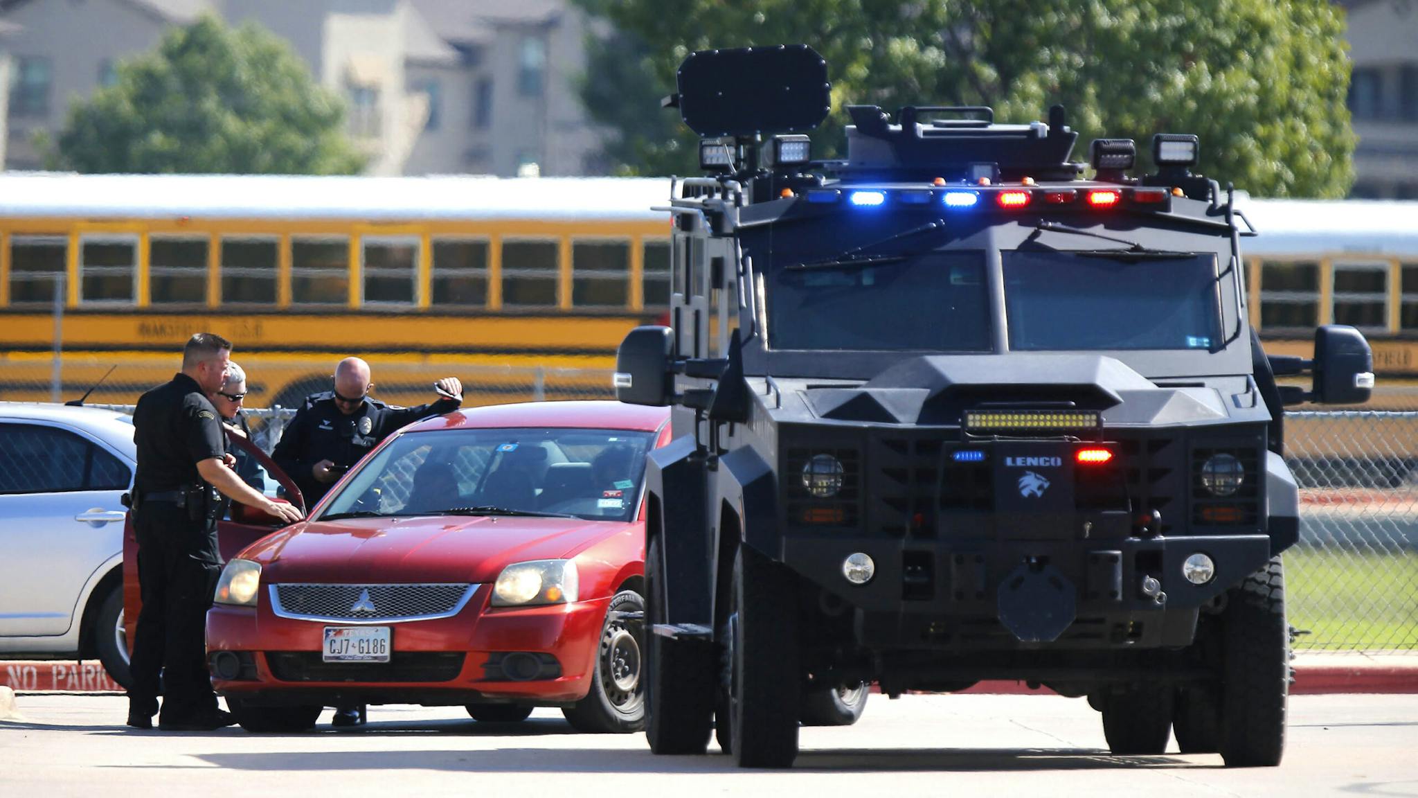 Shooting At Timberview High School In Arlington, Texas ARLINGTON, TX - OCTOBER 06: Emergency personnel work the scene in the parking lot at Timberview High School after a shooting on campus on October 6, 2021 in Arlington, Texas. According to reports, four people were injured in the shooting and a person of interest has been taken into custody.