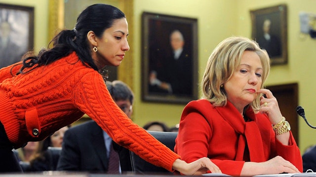 WASHINGTON, DC - MARCH 10: U.S. Secretary of State Hillary Clinton (R) receives a note from her aide Huma Abedin (L) as she testifies about the State Department's FY2012 budget during a hearing of the State, Foreign Operations and Related Programs Subcommittee of the House Appropriations Committee in the Rayburn House Office Building on March 10, 2011 in Washington, DC. Secretary Clinton has recently warned that proposed budget cuts would have a negative effect on U.S. national security policy. (Photo by