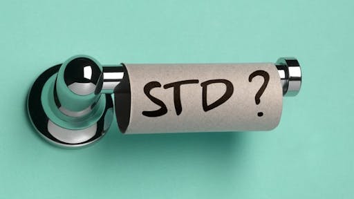 STD ON TOILET ROLL Close up of a toilet roll with STD written on it