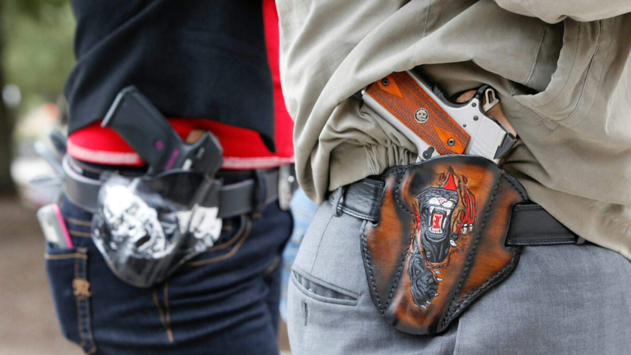Art and Diana Ramirez of Austin with their pistols in custom-made holsters during and open carry rally at the Texas State Capitol on January 1, 2016 in Austin, Texas.