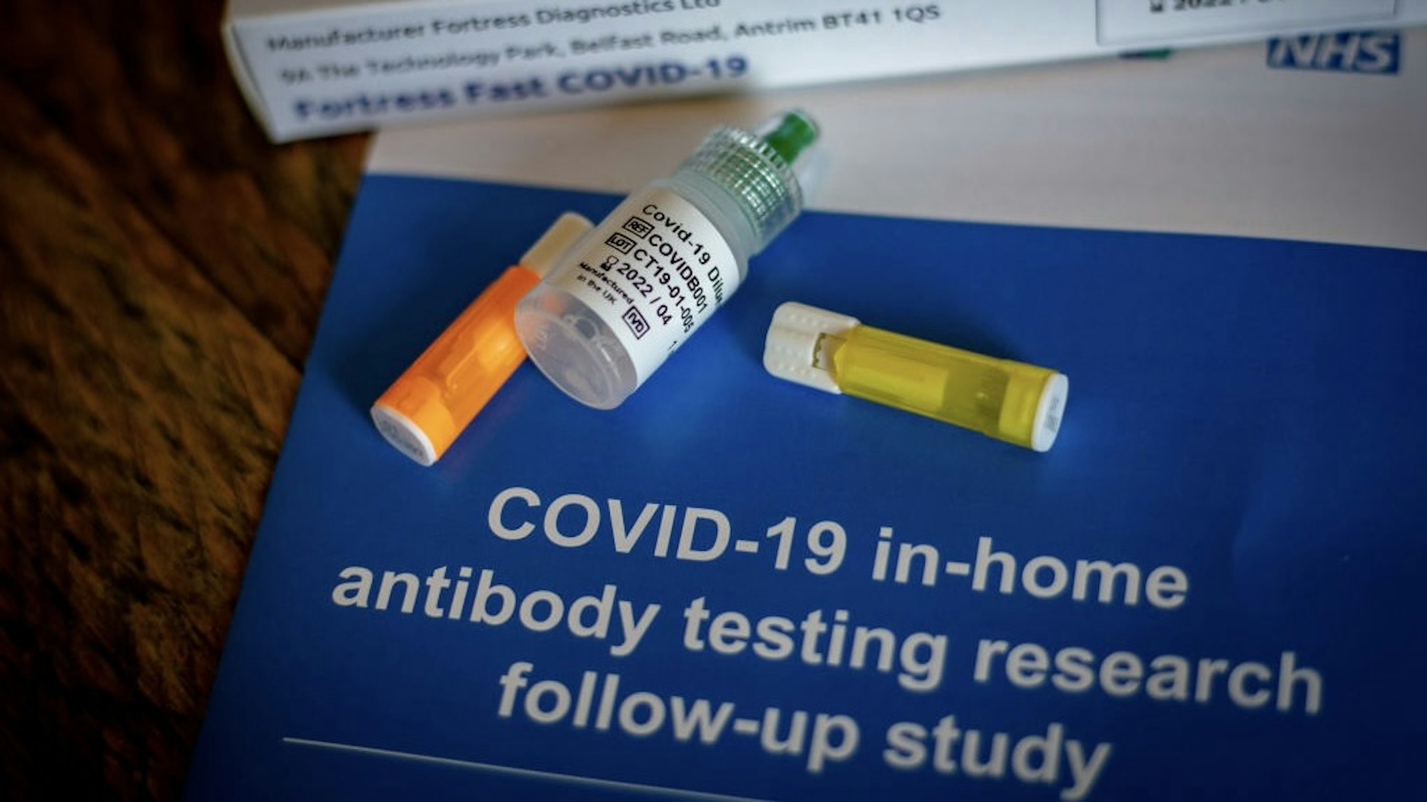 COVID-19 Home Antibody Testing Kit As U.K. Cases Soar A vial of COVID-19 diluent buffer liquid, center, and two lancets, part of a COVID-19 in-home antibody testing kit, manufactured by Fortress Diagnostics Ltd., sit in this arranged photograph in London, U.K., on Tuesday, Sept. 15, 2020. A new restriction on gatherings to no more than six people both indoors and outdoors started in the U.K. on Monday as coronavirus cases rose sharply and a prominent scientist warned of future lockdowns. Photographer: Gem Atkinson/Bloomberg via Getty Images Bloomberg / Contributor