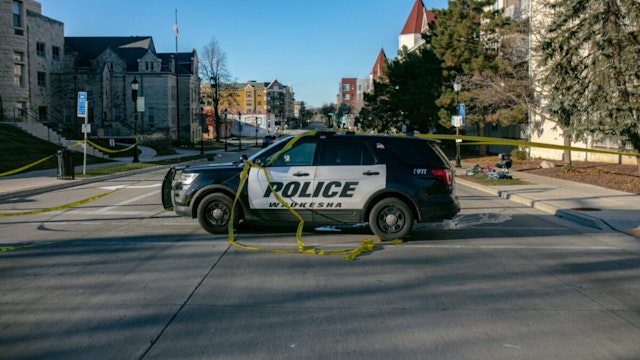 Police block off road entrances following a driver plowing into the Christmas parade on Main Street in downtown November 22, 2021 in Waukesha, Wisconsin.