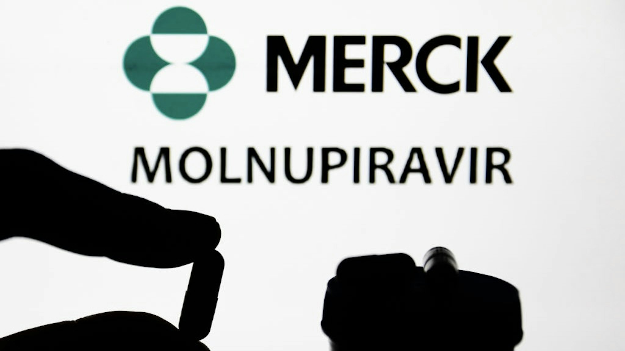 Molnupiravir Photo Illustrations Medicine pill is seen with Merck logo and the wrod 'molnupiravir' displayed on a screen in the background in this illustration photo taken in Poland on November 5, 2021. (Photo by Jakub Porzycki/NurPhoto via Getty Images) NurPhoto / Contributor