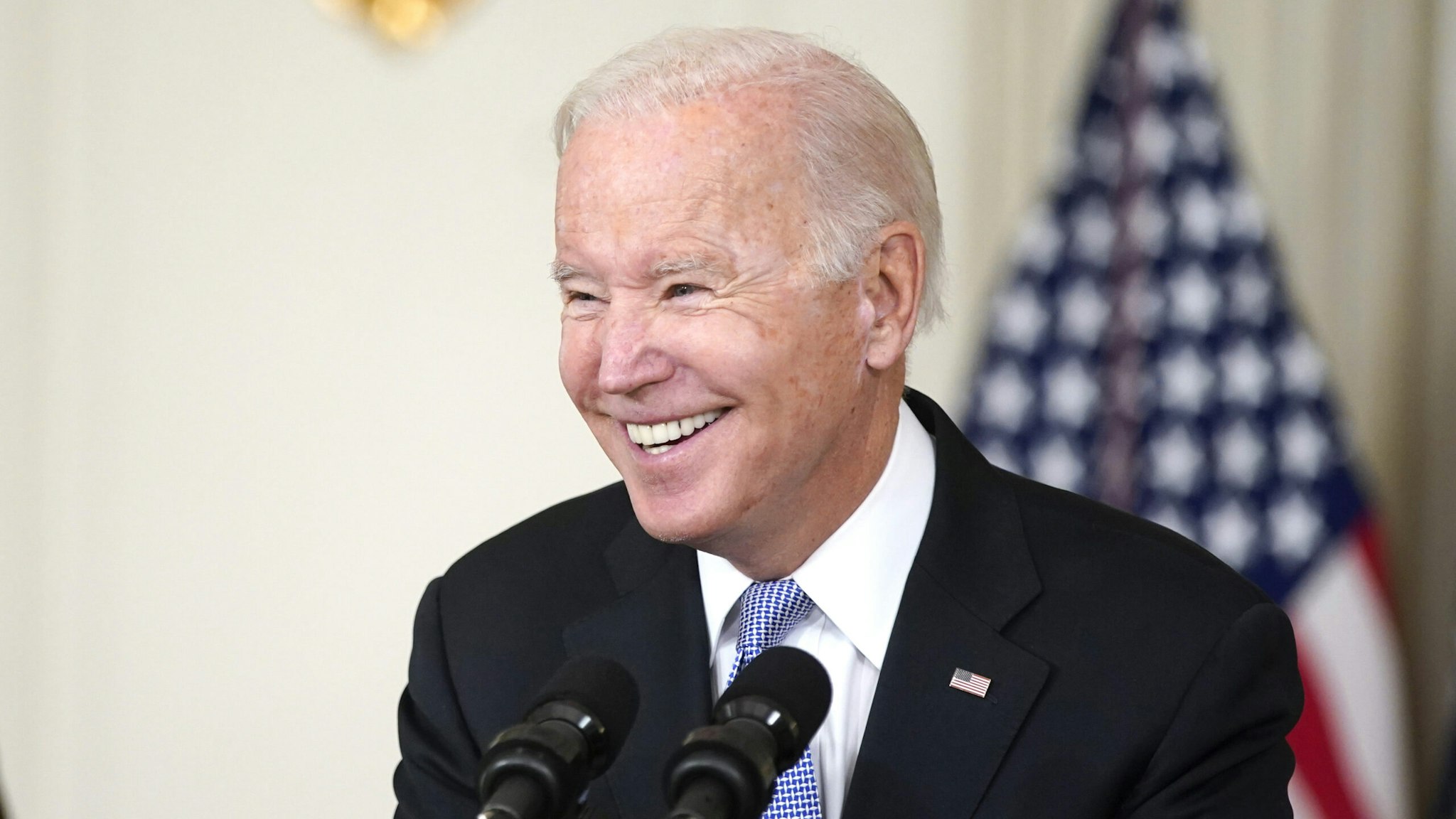 U.S. President Joe Biden smiles while speaking on the passage of the Bipartisan Infrastructure Deal as U.S. Vice President Kamala Harris, left, listens in the State Dining Room of the White House in Washington, D.C., U.S., on Saturday, Nov. 6, 2021. The House on Friday passed the biggest U.S. infrastructure package in decades, marking a victory for President Biden and unleashing $550 billion of fresh spending on roads, bridges, public transit and other projects in coming years.